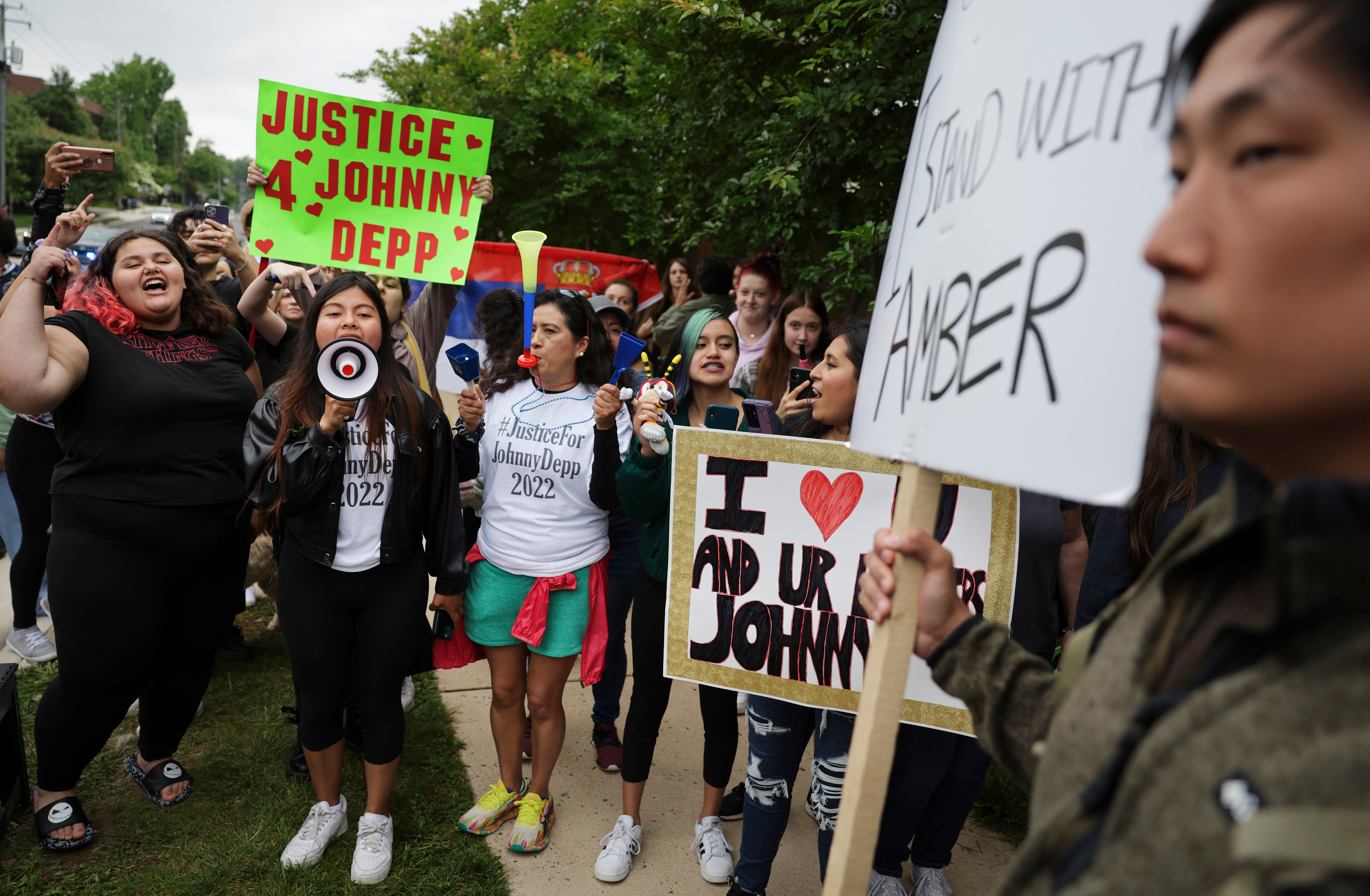 Supporters standing outside the US trial in Fairfax, Virginia, in May 2022