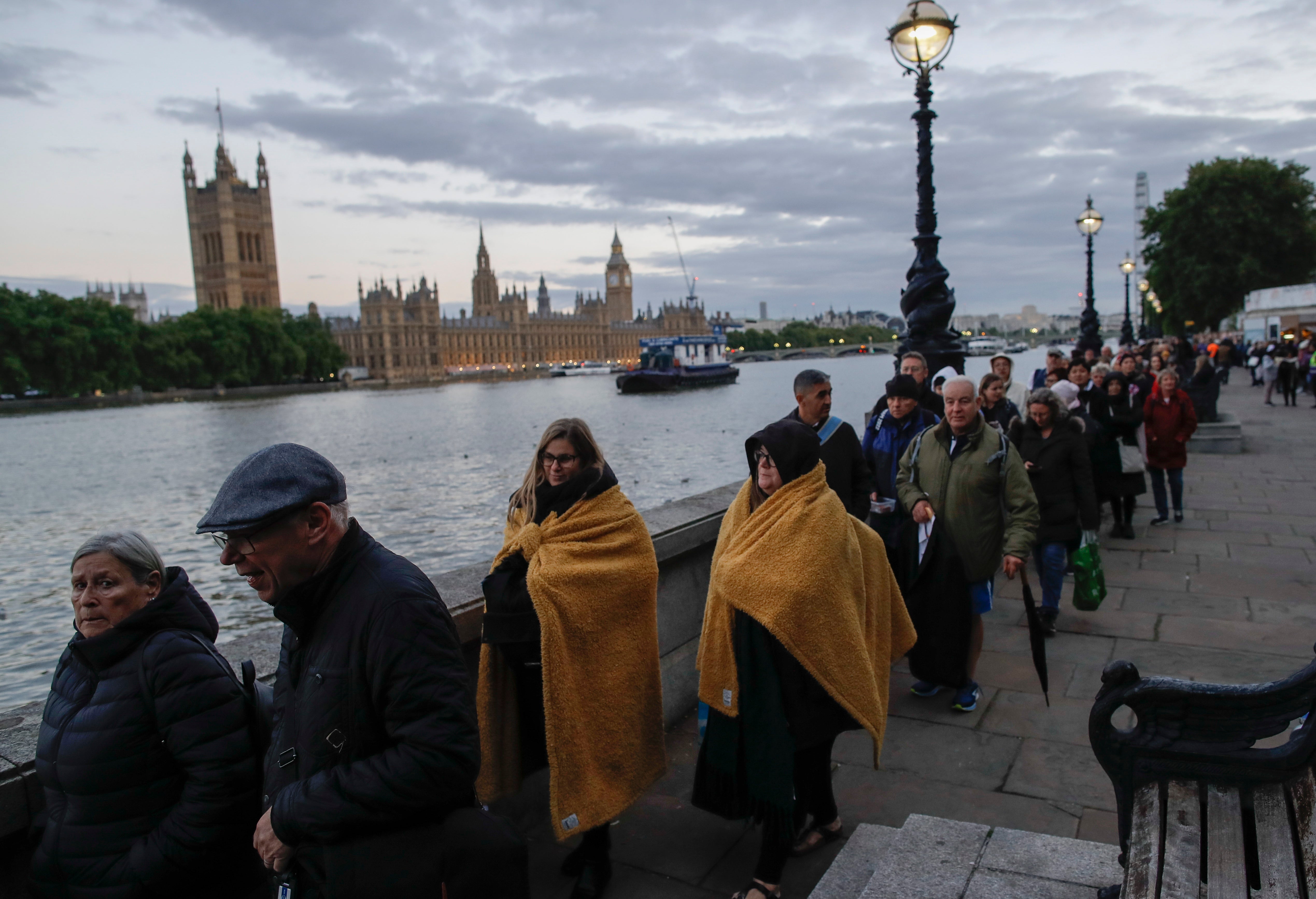 People queue to view the Queen lying-in-state only minutes away from where the attack occurred