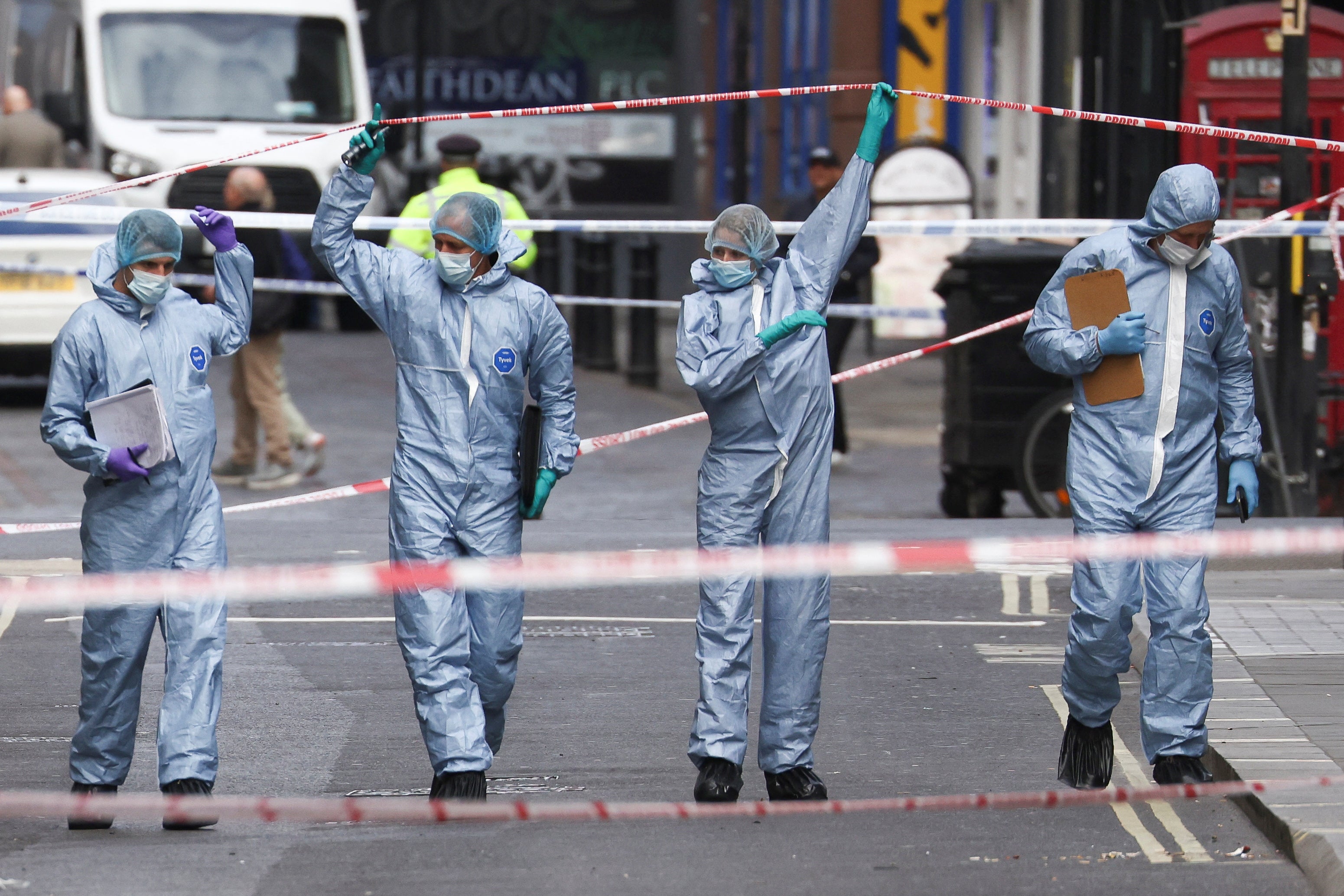 Forensic officers work at the scene