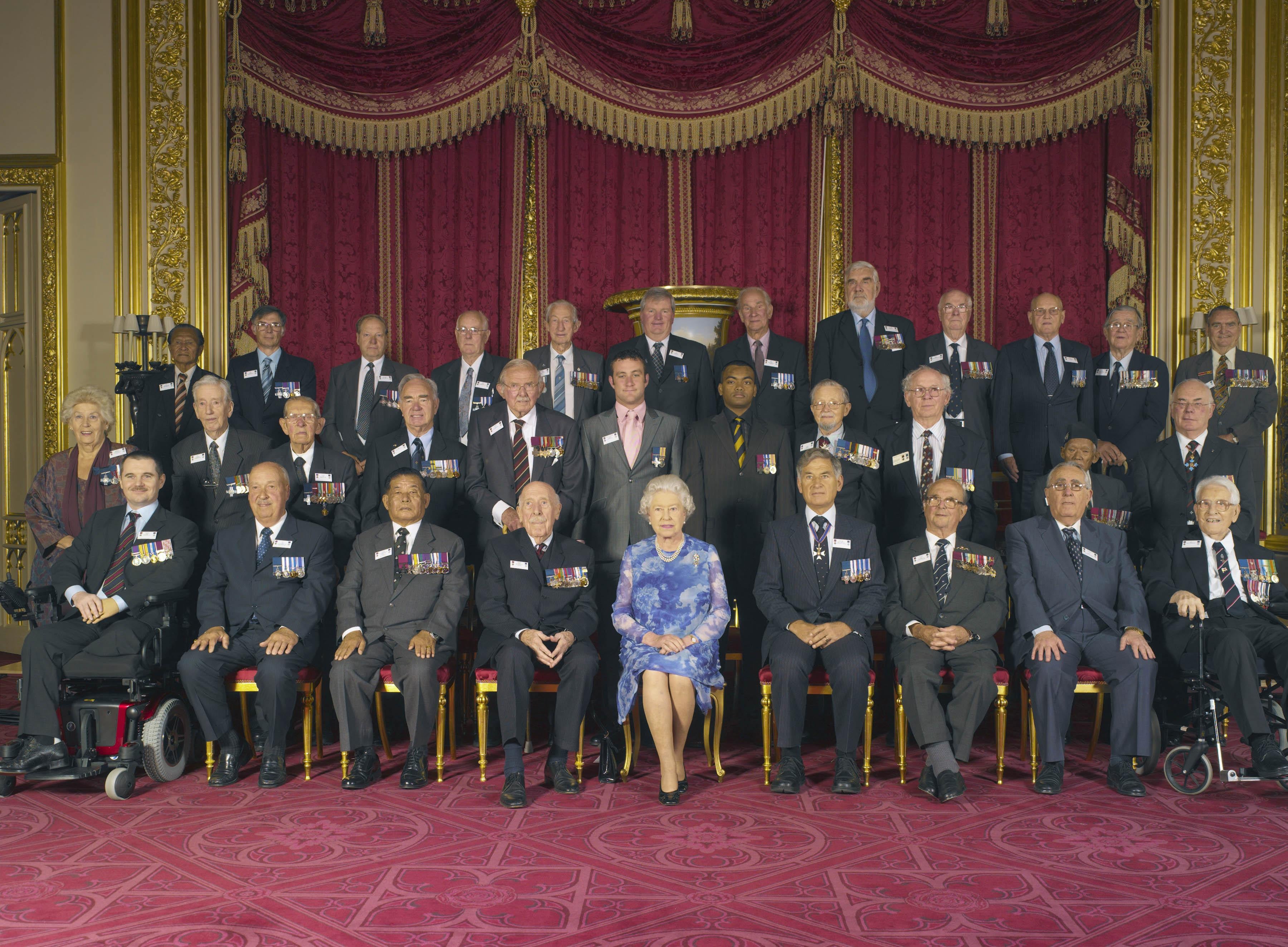 The Queen with Victoria Cross and George Cross holders at a reception at Windsor Castle in 2006 (Richard Bayford/PA)