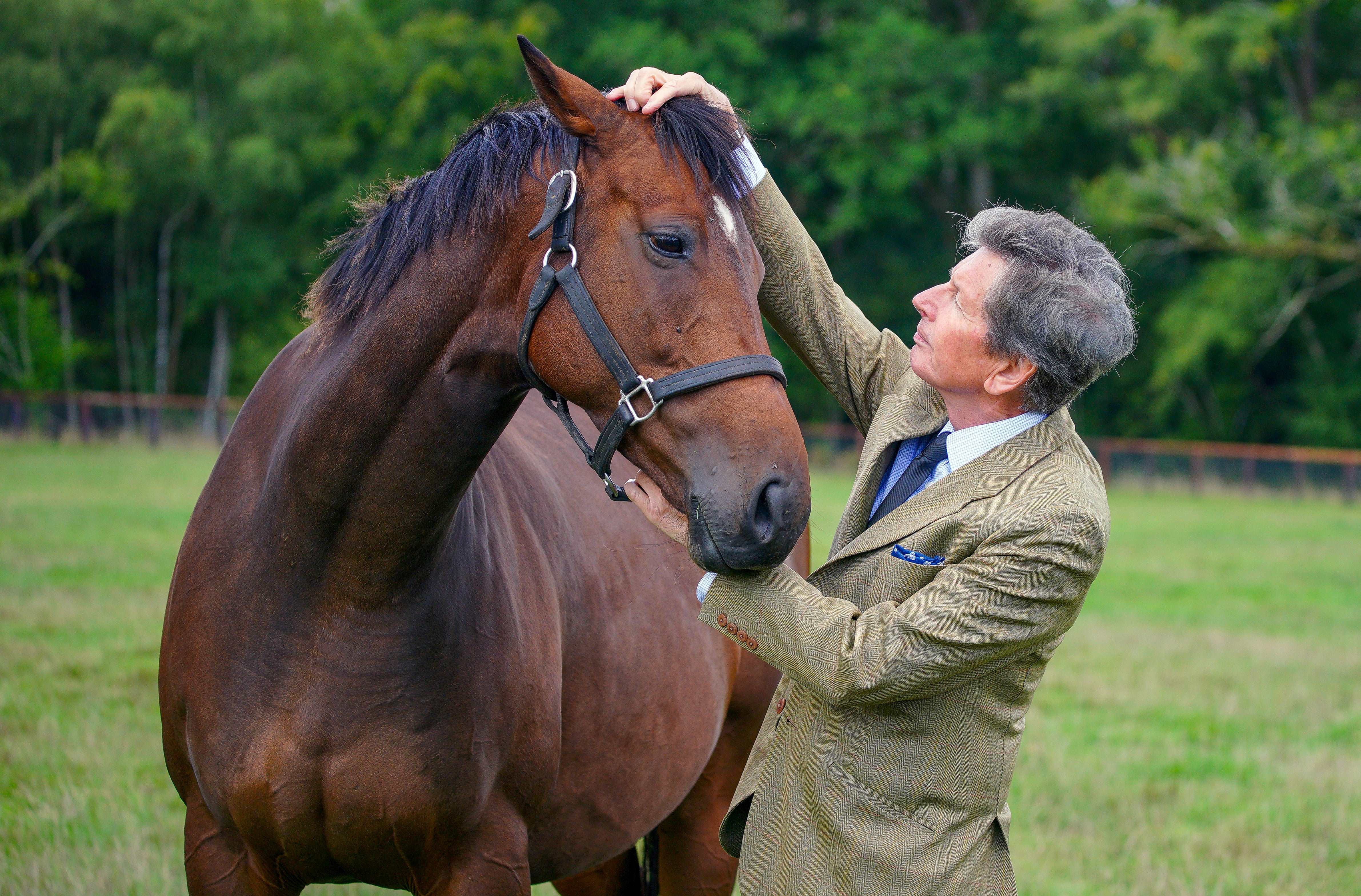 John Warren, the Queen’s racing manager, with horse Hostess at his home in Newbury (Peter Byrne/PA)