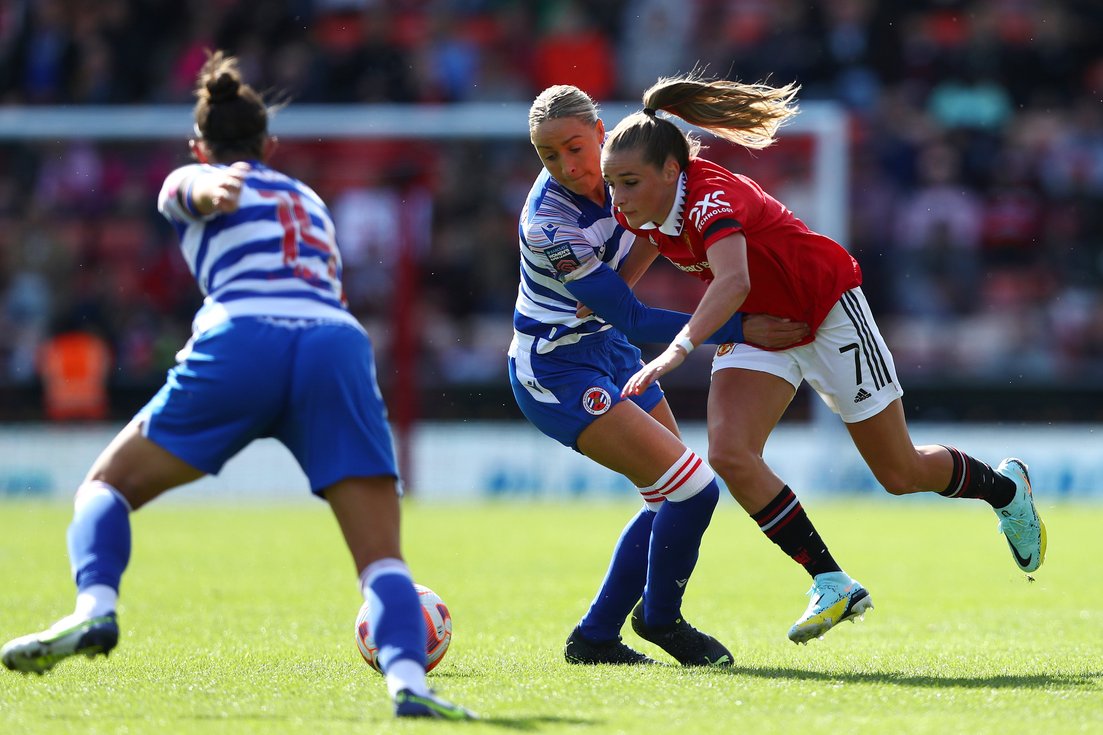 Ella Toone (right) looks to break past Reading’s Gemma Evans during Manchester United’s opening-day win in the Women’s Super League (Tim Markland/PA)