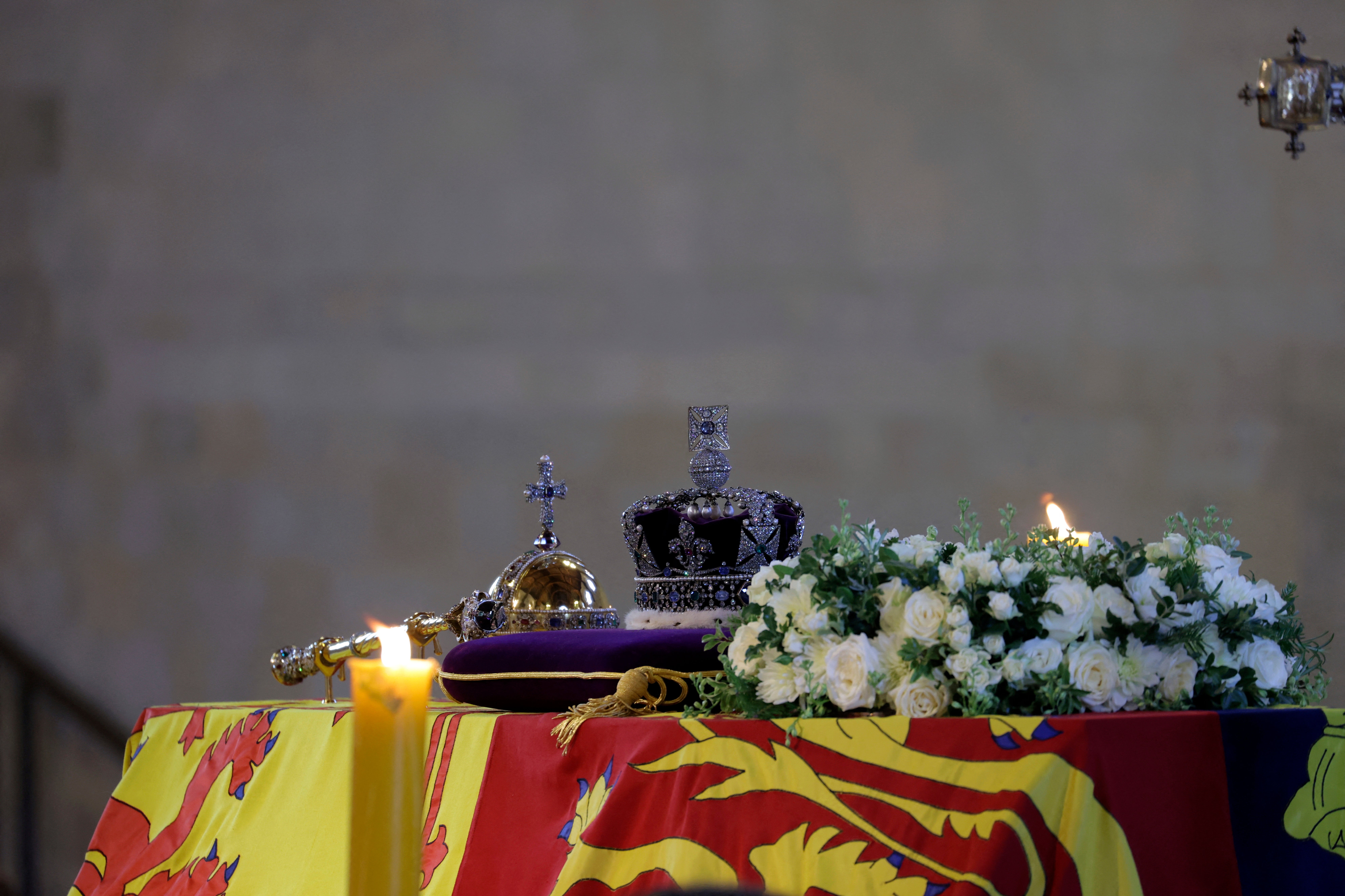 The coffin of Queen Elizabeth, draped in the Royal Standard with the Imperial State Crown and the Sovereign's orb and sceptre, on the catafalque inside Westminster Hall