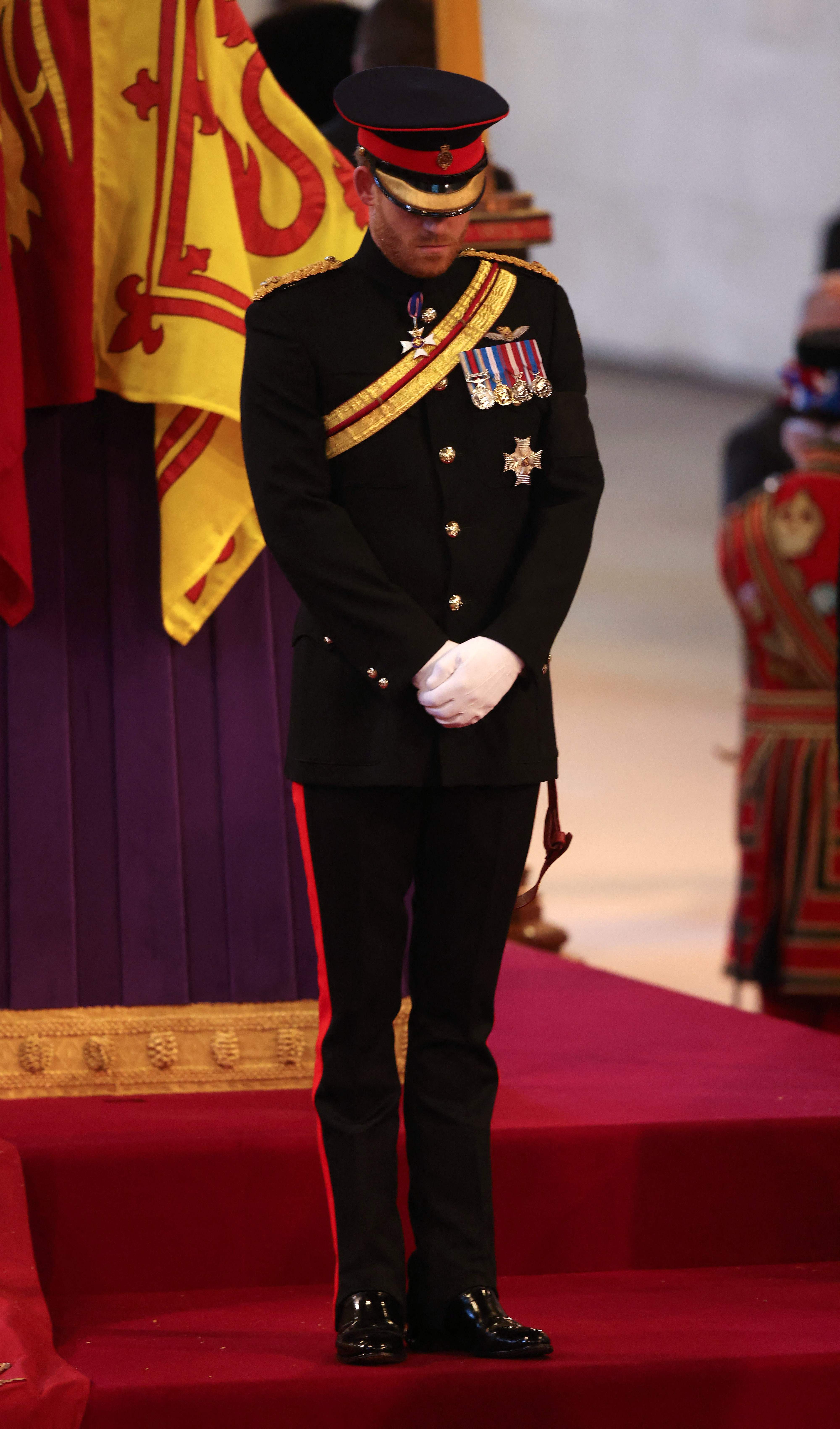 The Duke of Sussex stood beside his grandmother’s coffin as huge queues file past her coffin to pay their respects