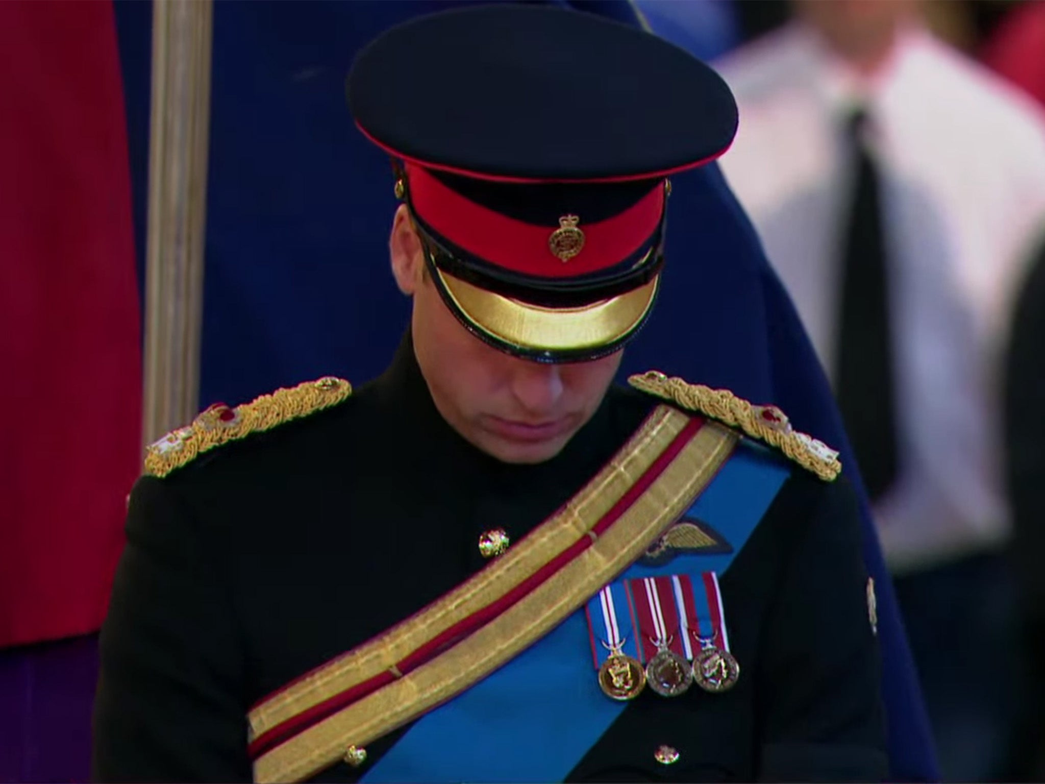 The Prince of Wales stands at the head of the coffin of Queen Elizabeth II