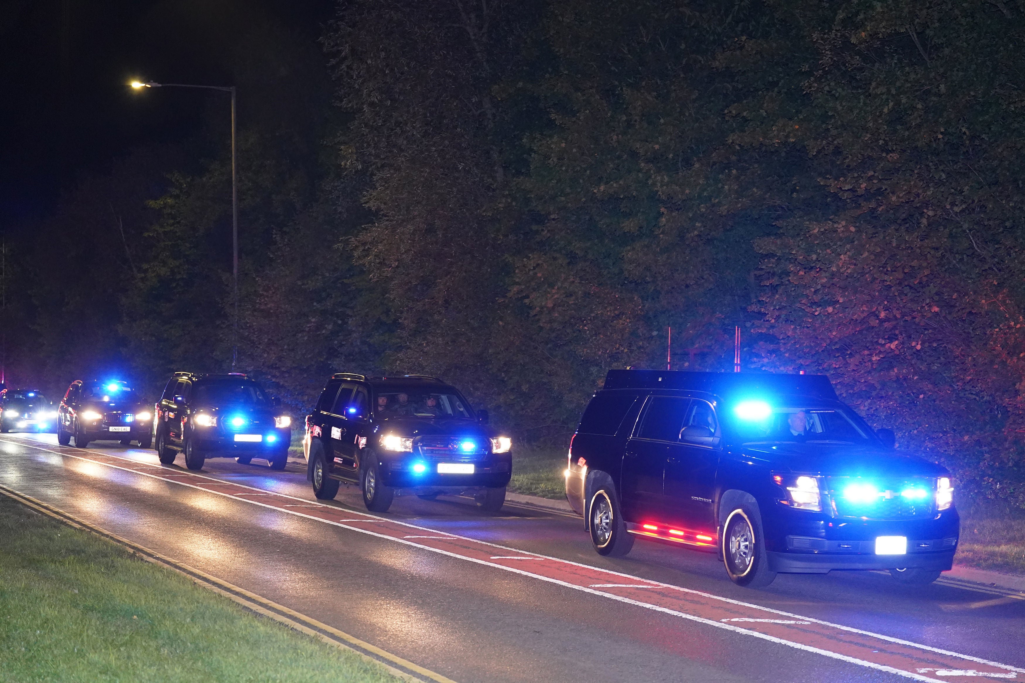 The Bidens are flanked by a convoy of cars on their way to London