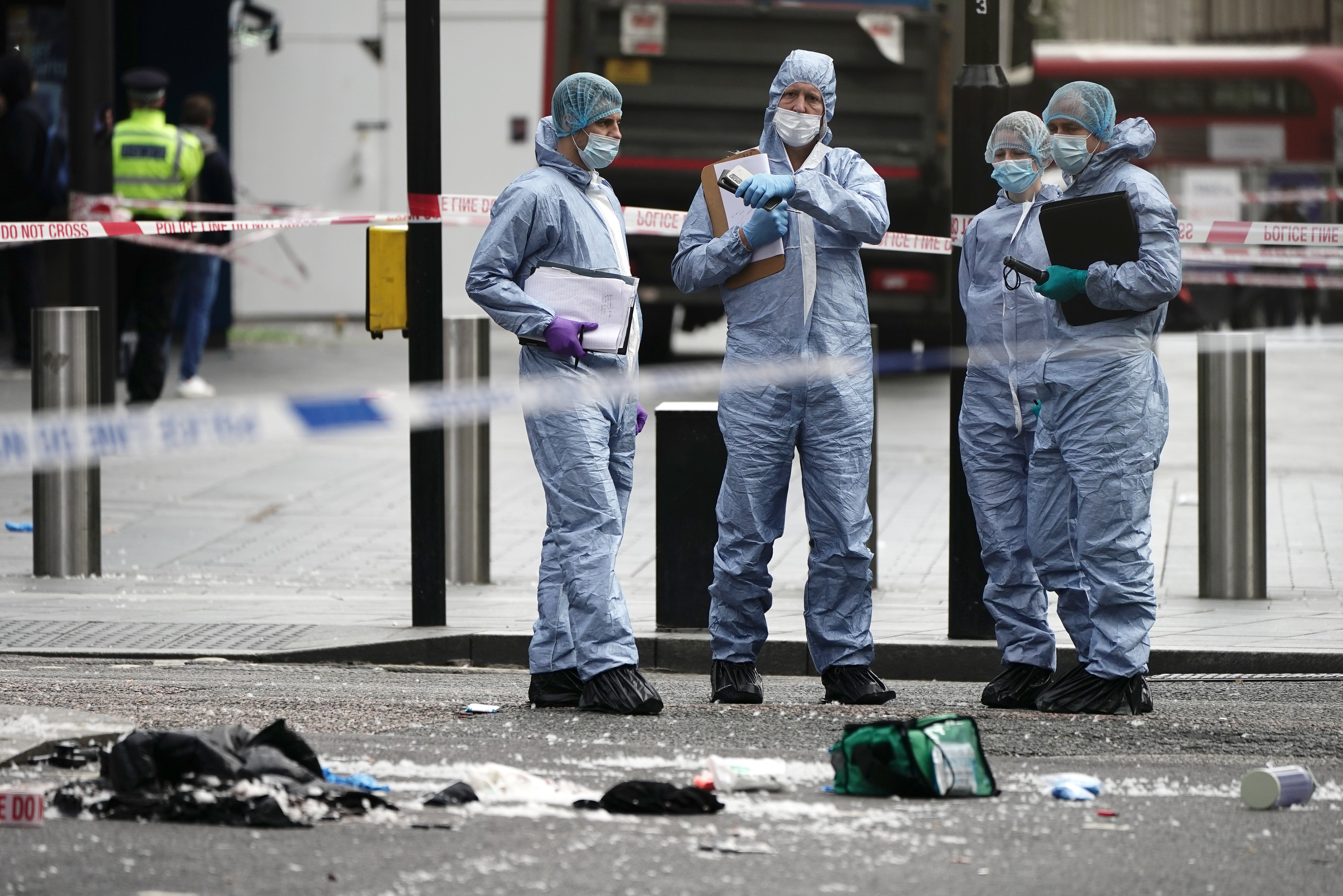 Forensics officers and police at the scene in Shaftesbury Avenue (PA)