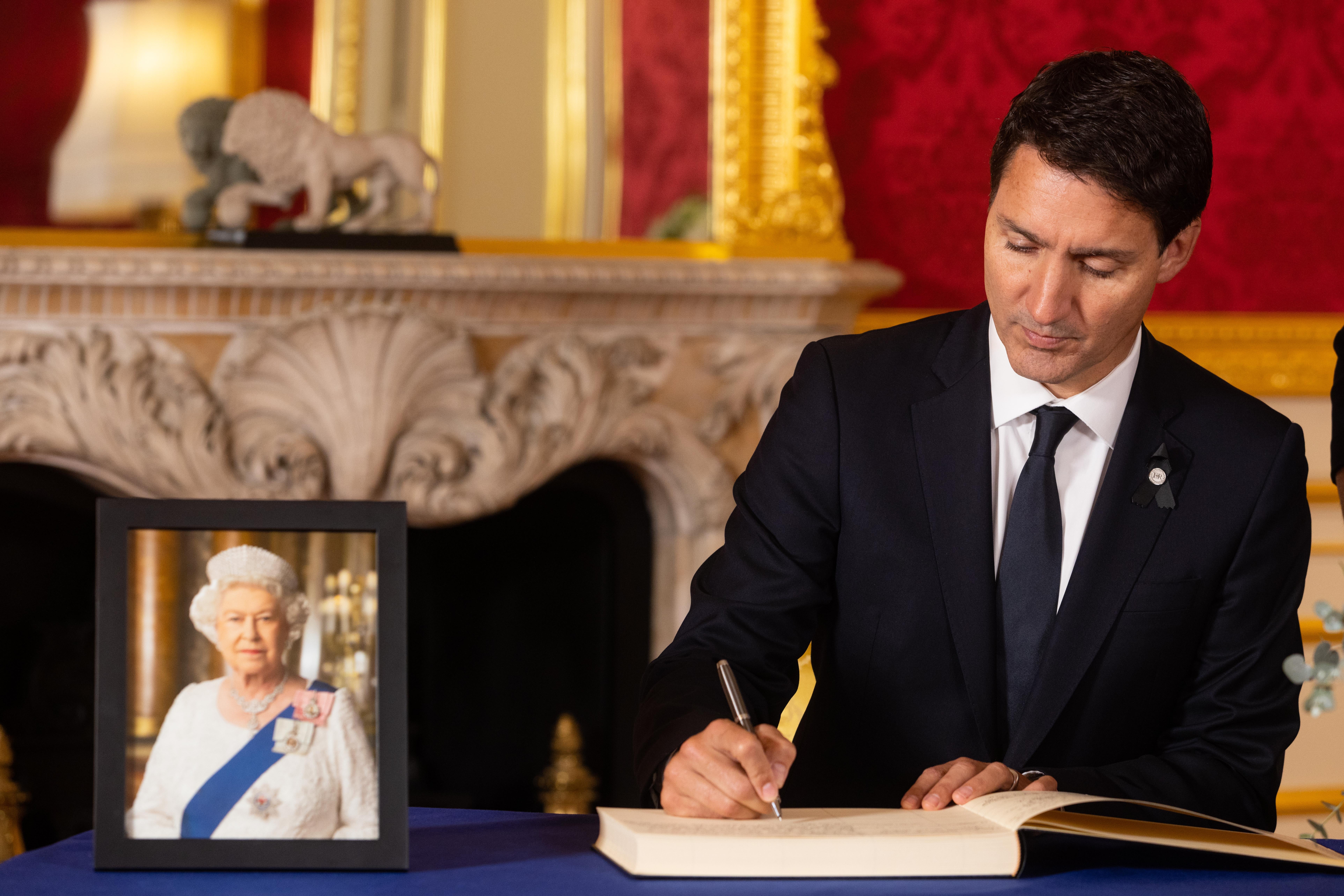 Canadian prime minister Justin Trudeau signs the book of condolence at Lancaster House (David Parry Media Assignments/PA)