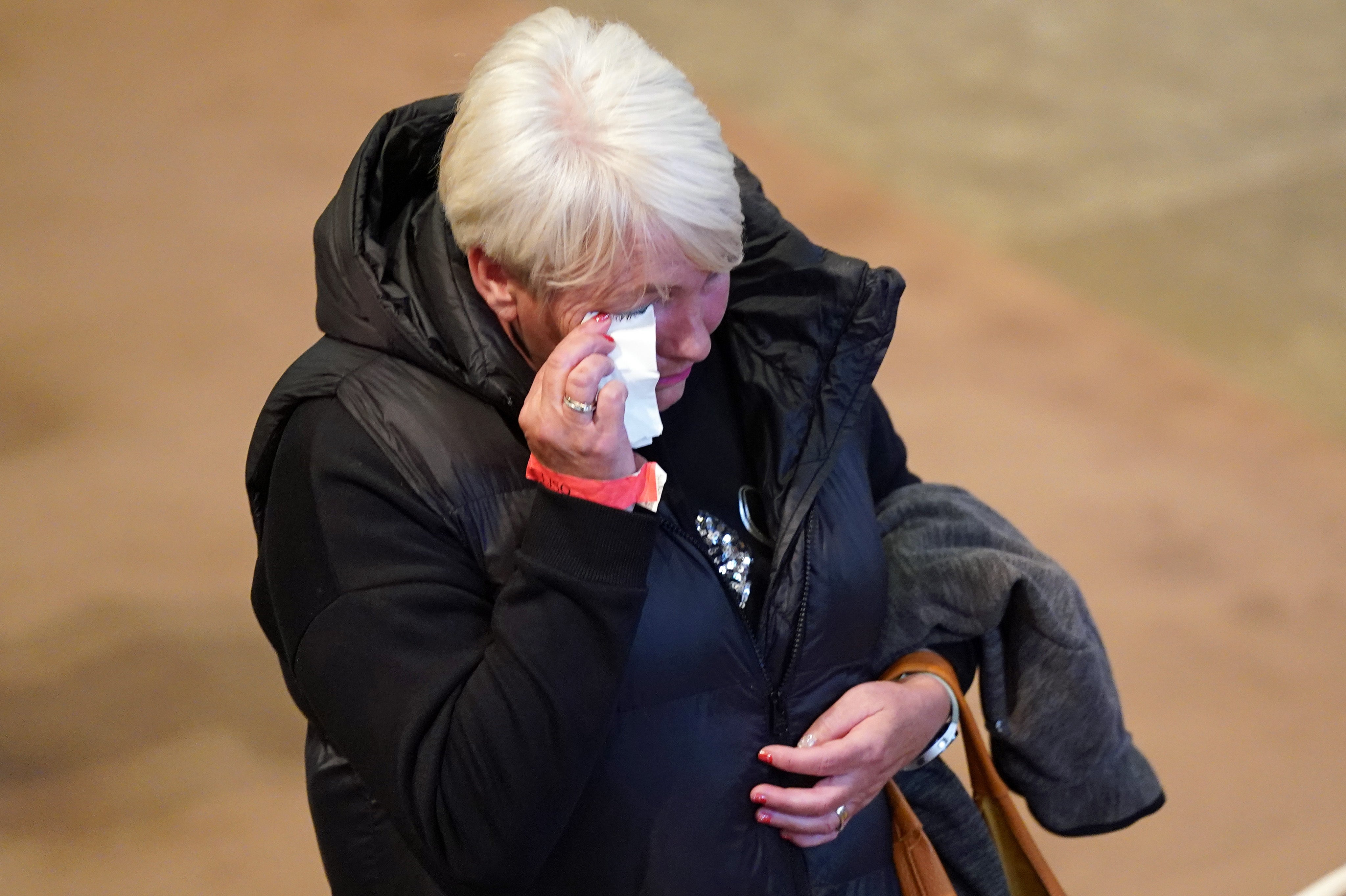 A member of the public is visibly upset as they view the coffin of the late monarch