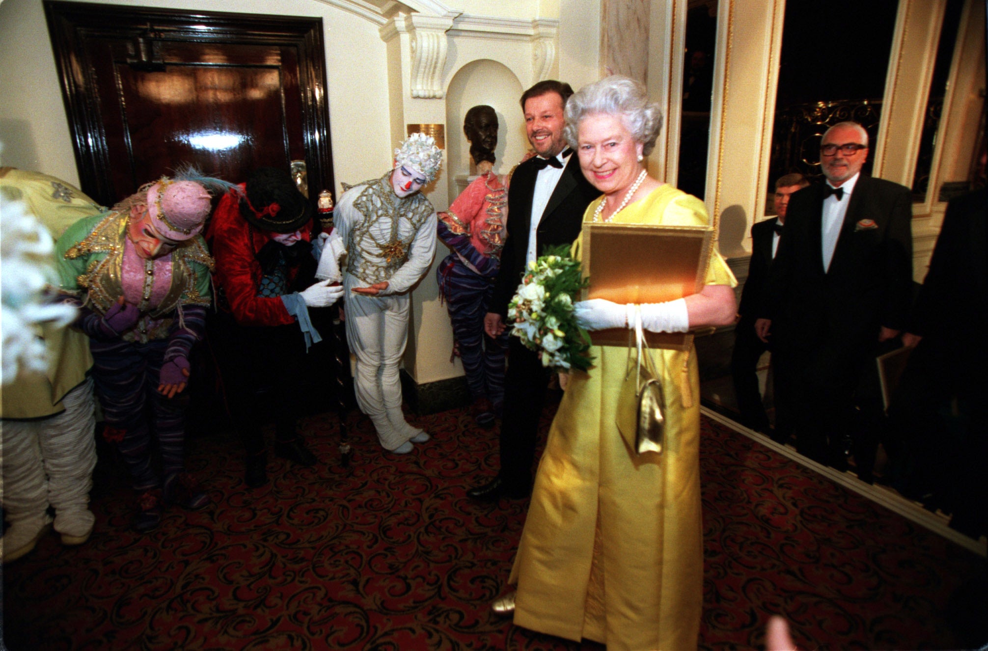 The Queen is greeted by the Cirque du Soleil’s Alegria at the Royal Variety Performance at the Victoria Palace Theatre in London (PA)