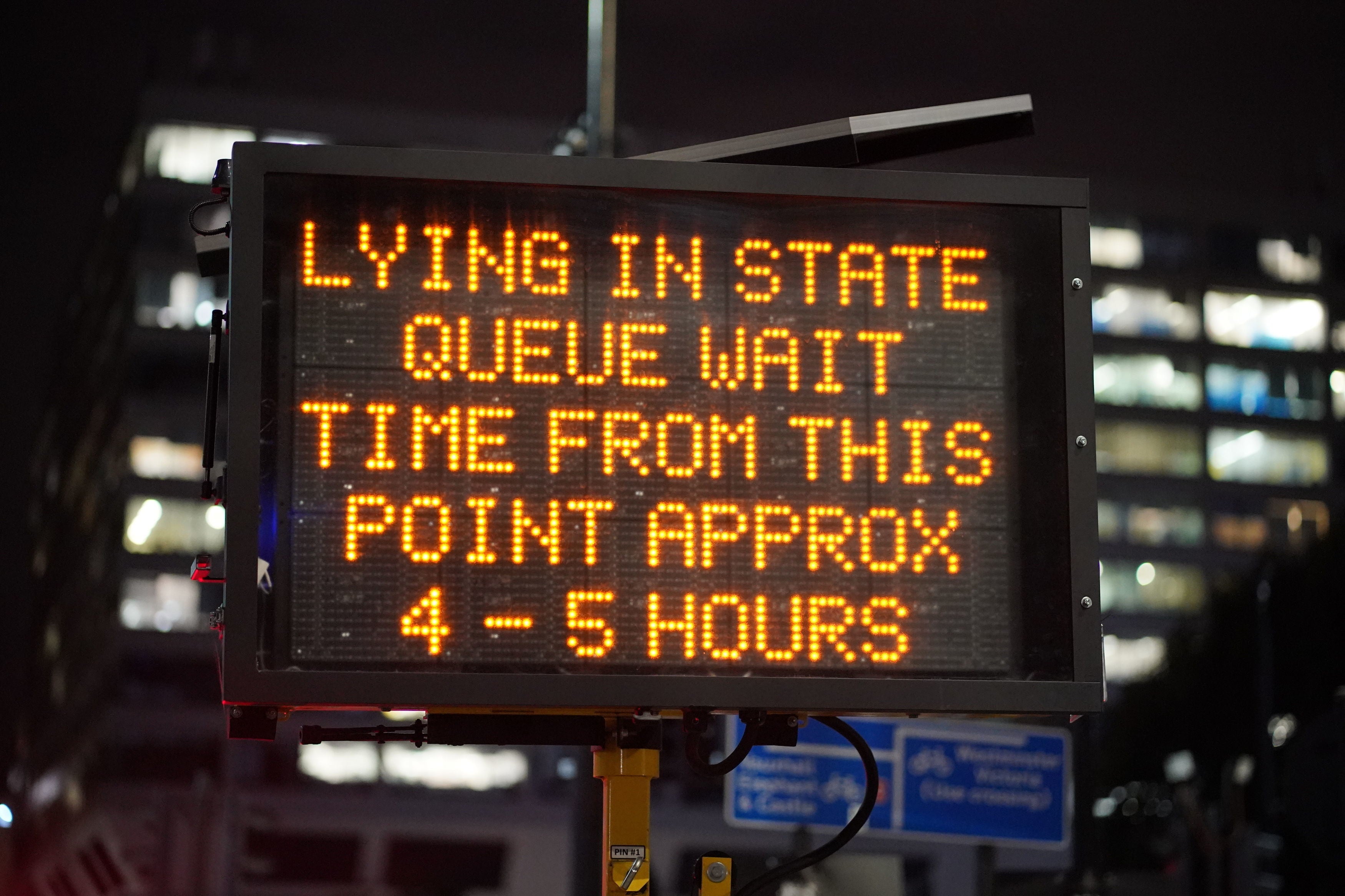 A sign in Westminster indicates the waiting time for the queue to view the Queen’s coffin