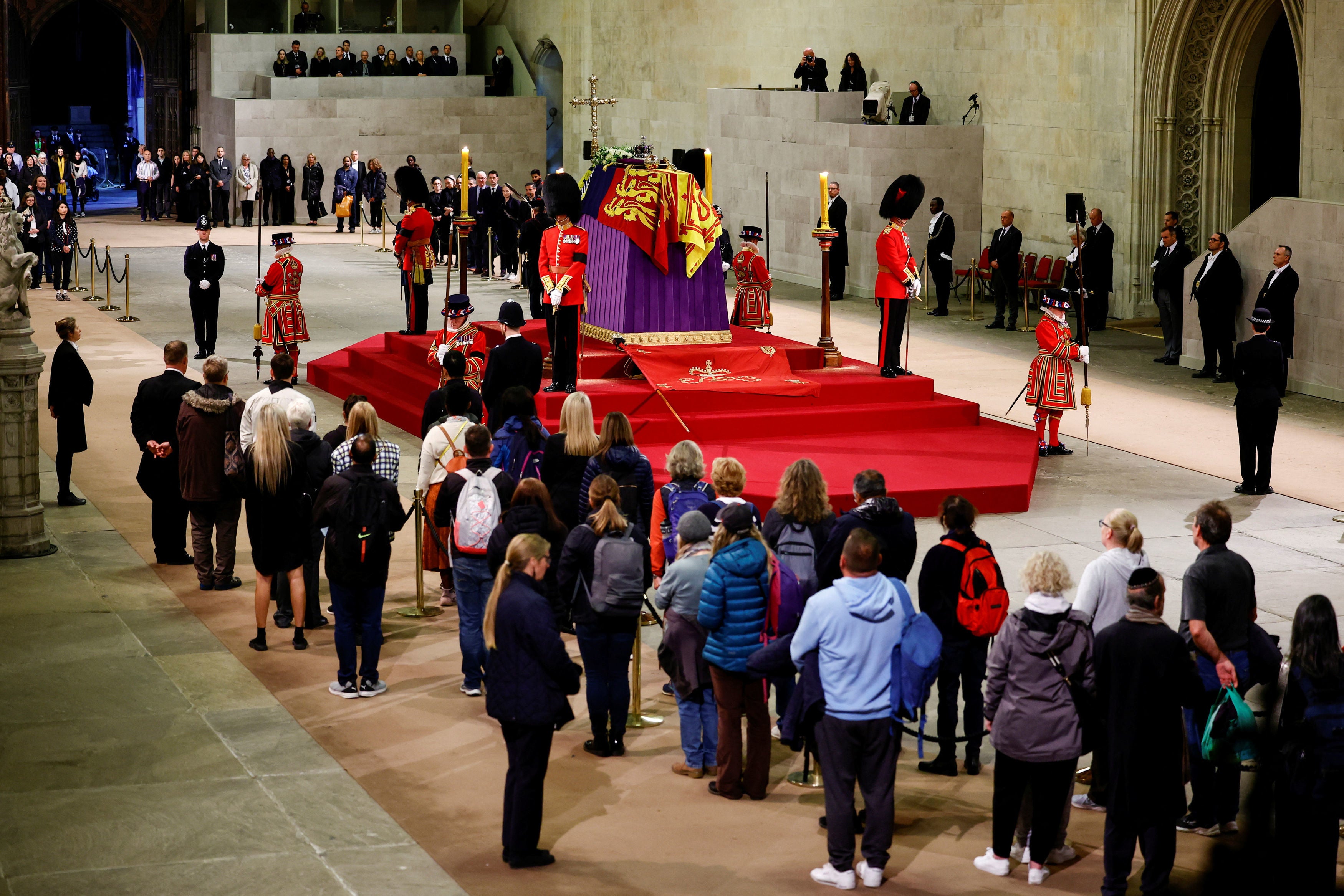 Beefeaters stand. guard at Westminster Hall, where the coffin of the Queen is lying in state on the catafalque