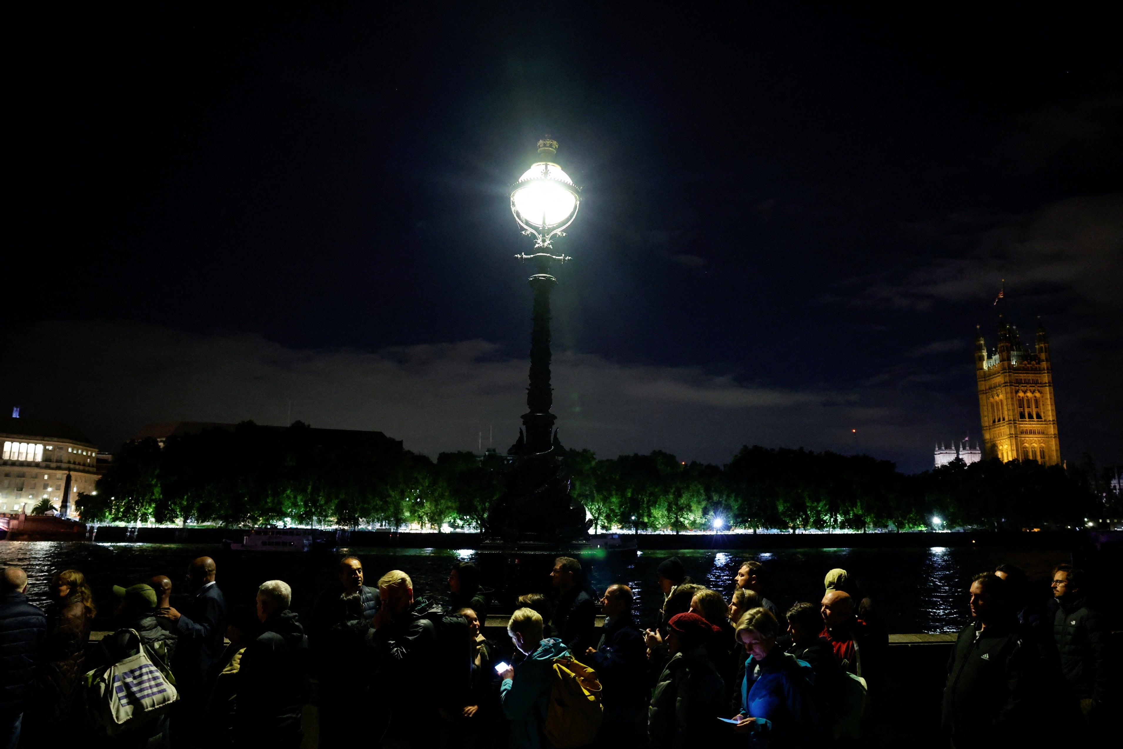 People queue outside the Houses of Parliament to pay their respects to the Queen