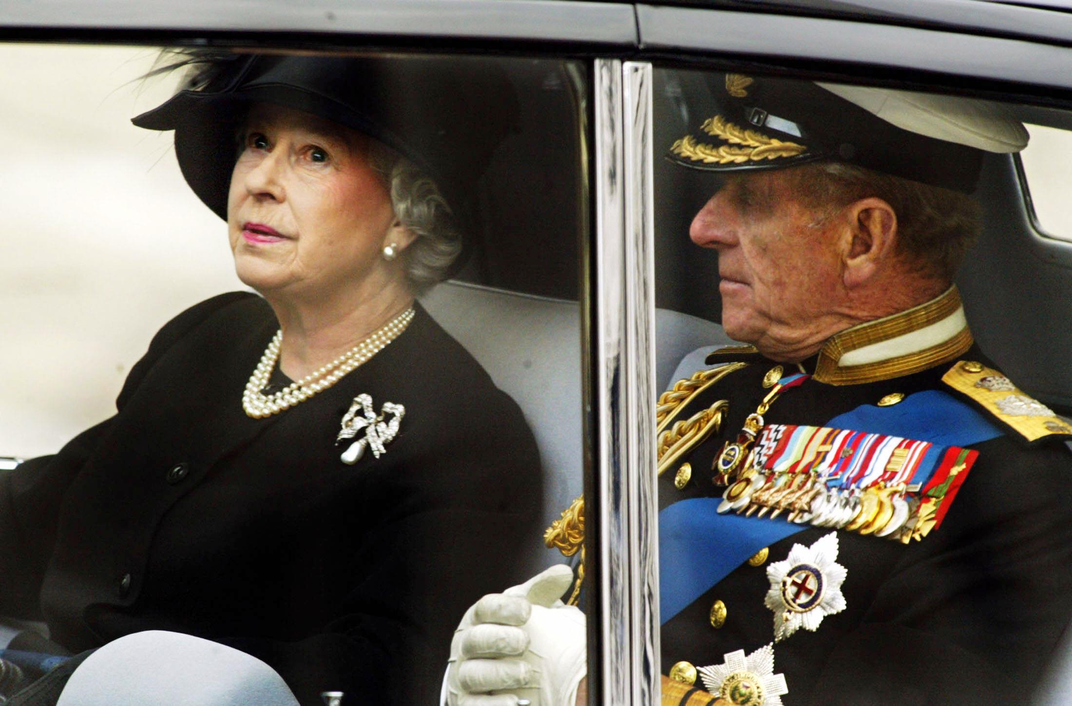 The Queen leaves Westminster Abbey with the Duke of Edinburgh after the funeral ceremony of the Queen Mother