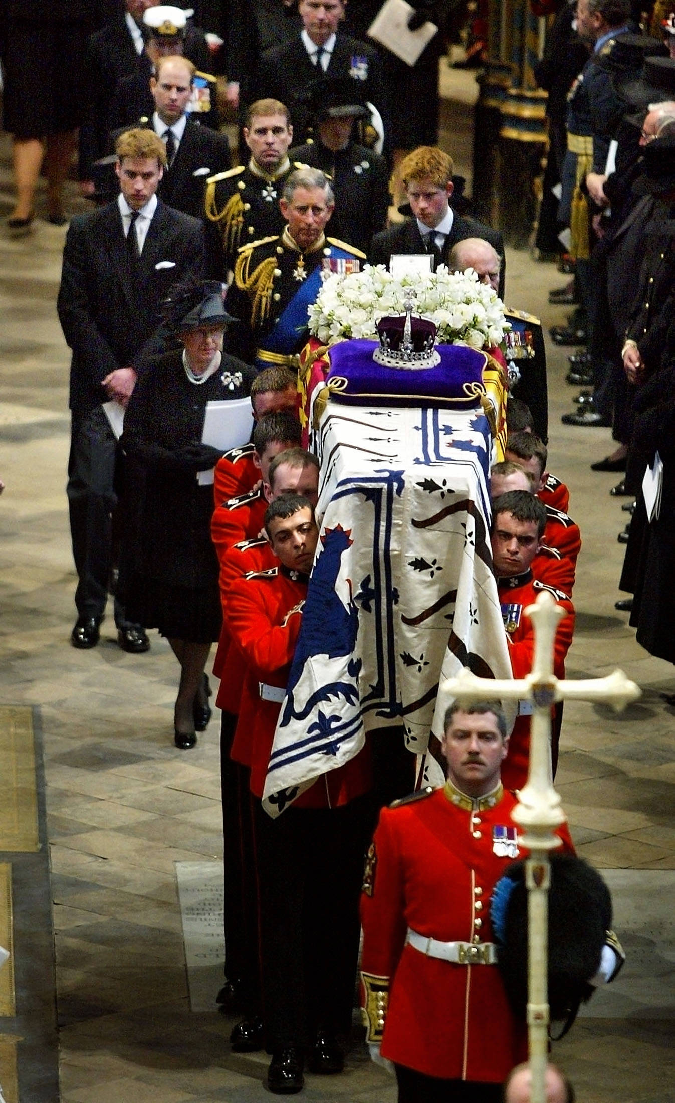 The royal family follows the Queen Mother's coffin out of Westminster Abbey after the funeral service