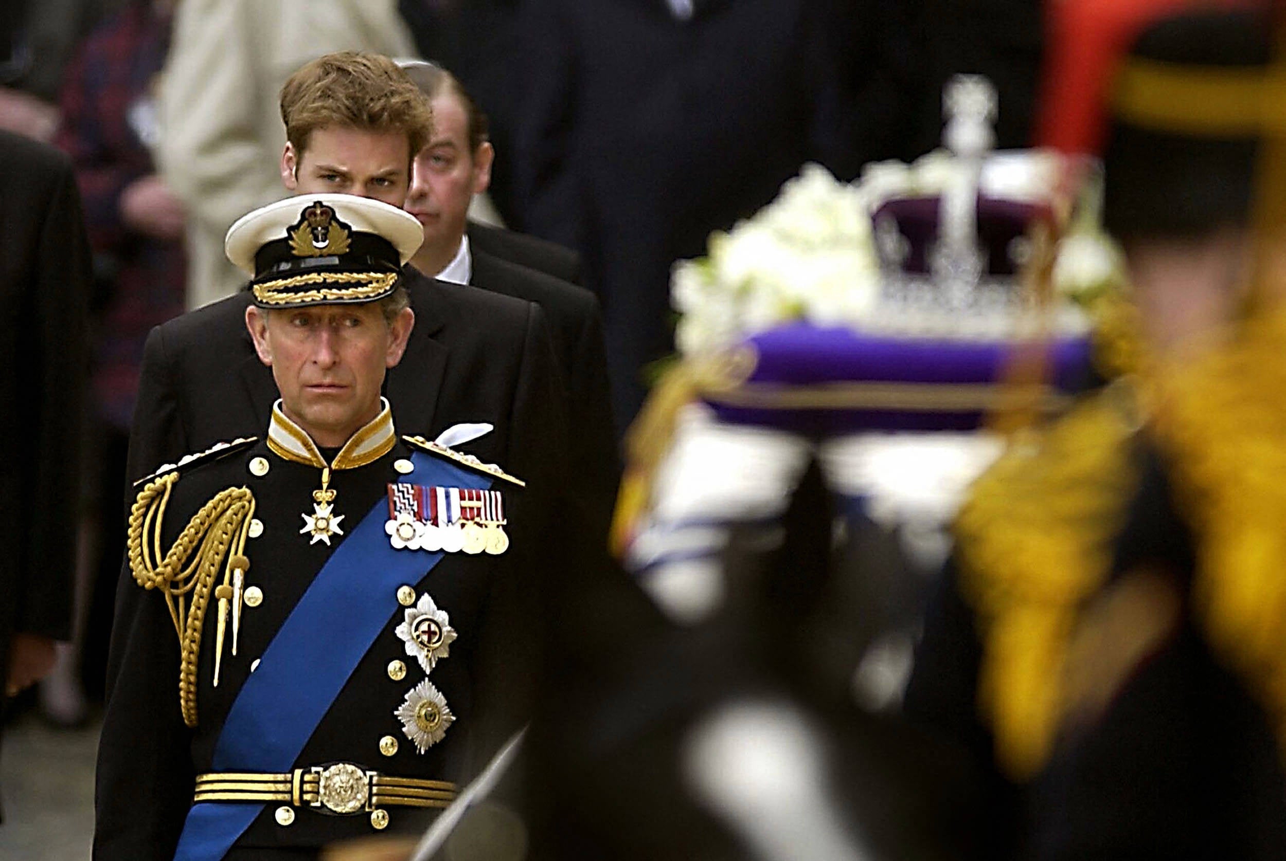 Prince Charles observes the Queen Mother's coffin