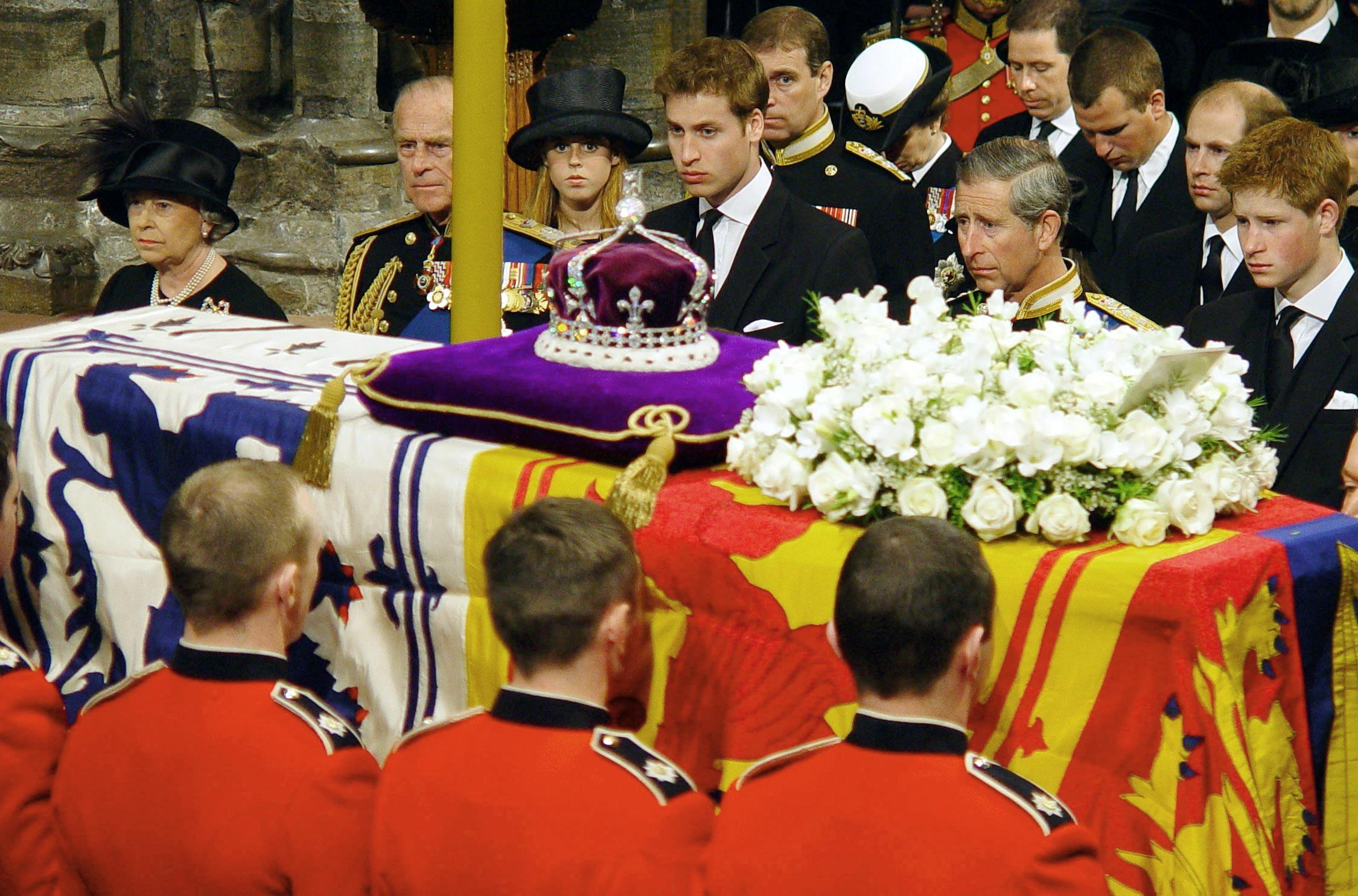 The royal family watch as the coffin of Queen Elizabeth, the Queen Mother, is prepared to be carried from Westminster Abbey at the end of her funeral service