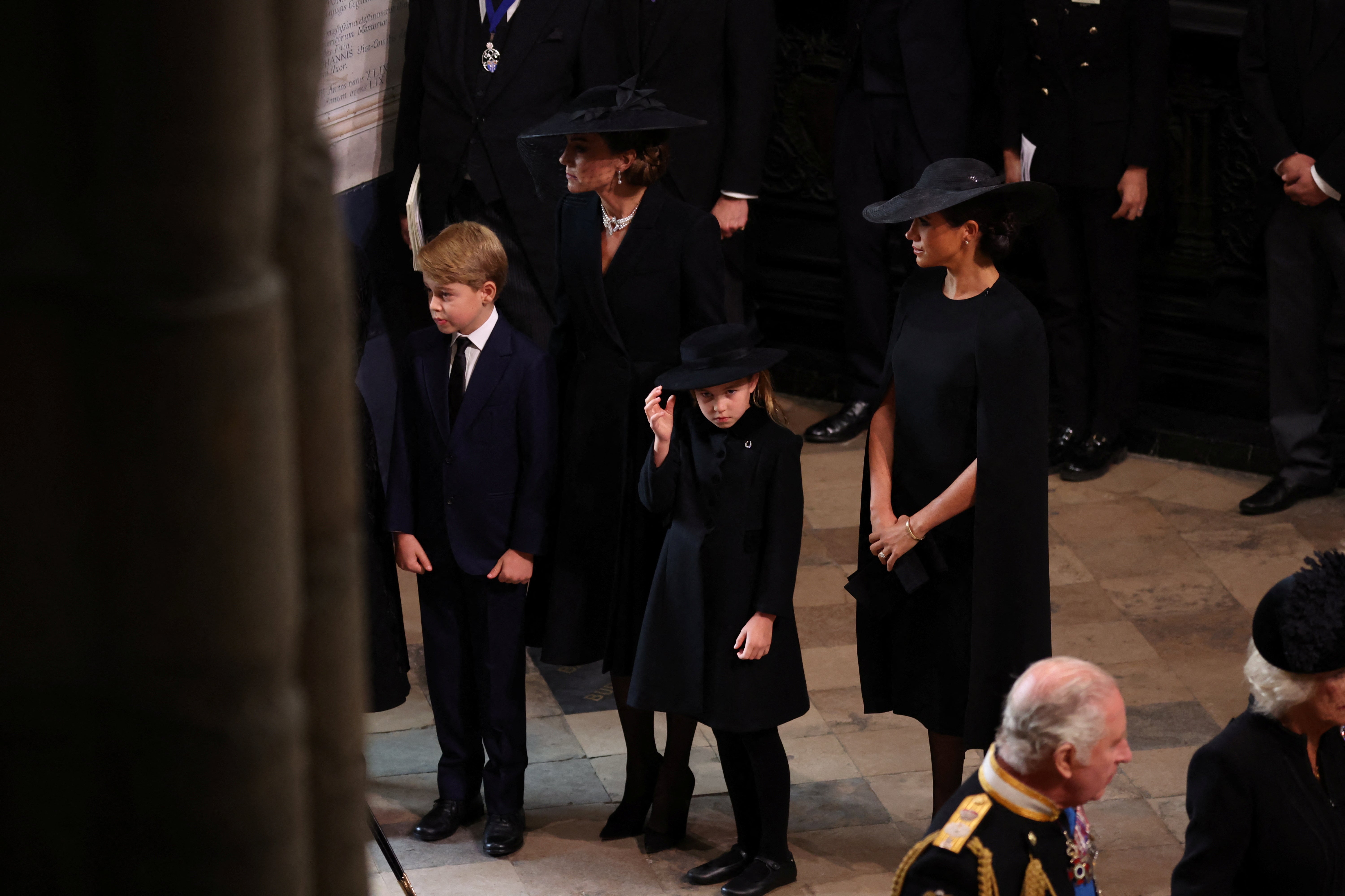 Prince George and Princess Charlotte walked in the procession of royals, accompanied by the Princess of Wales and the Duchess of Sussex, behind the Queen’s coffin