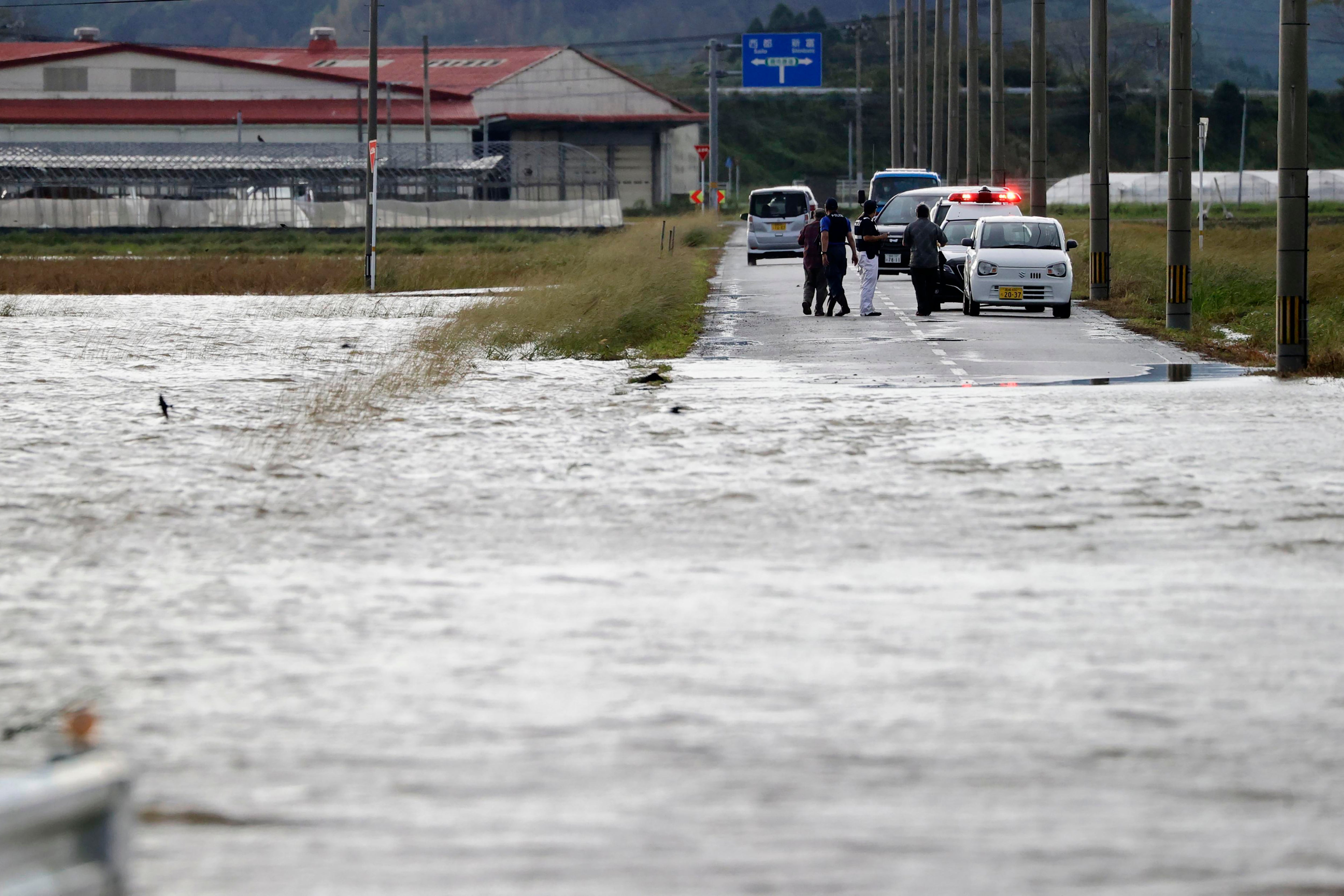 A road is submerged under water in Saito, Miyazaki prefecture in Japan on Monday