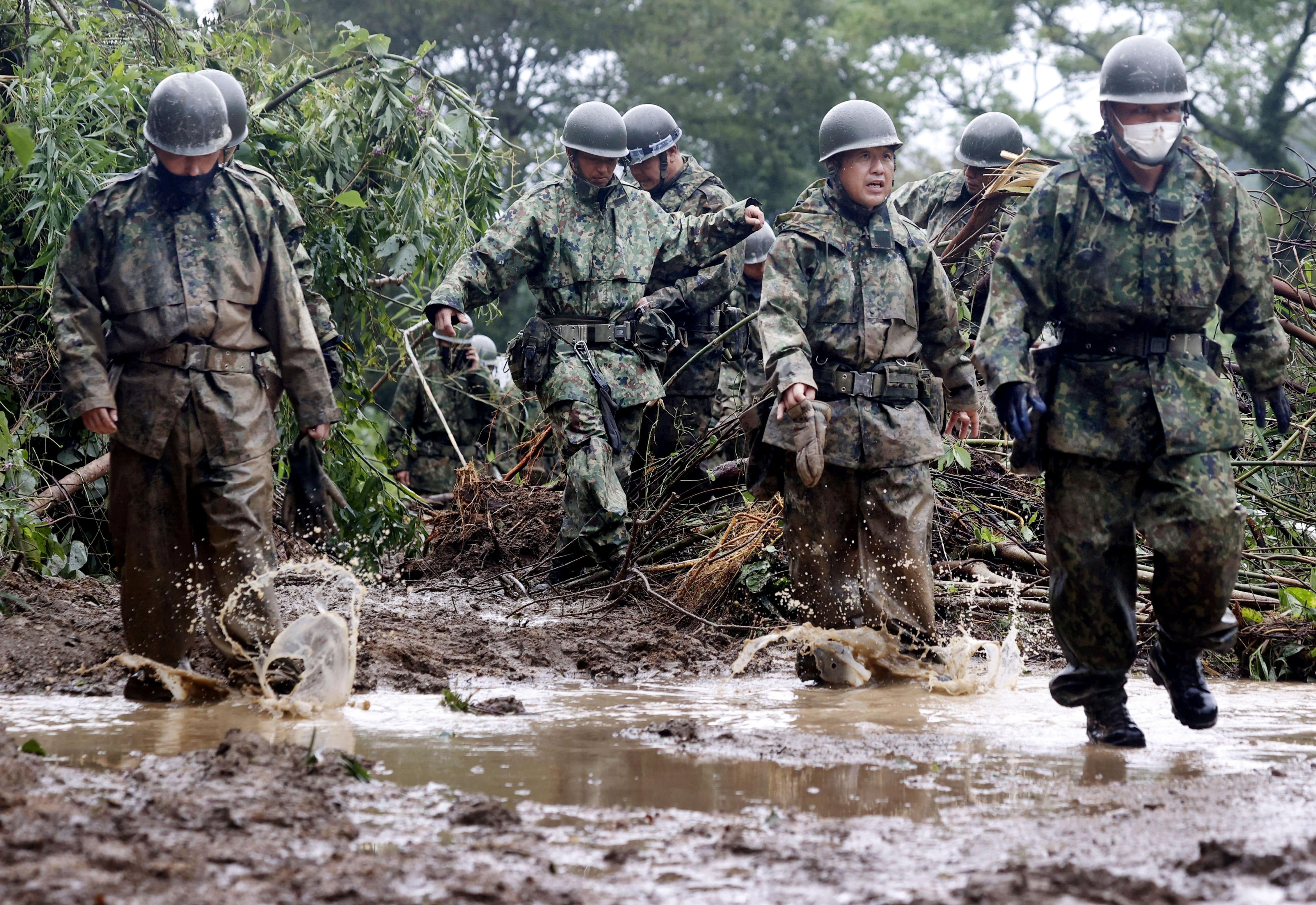 Japanese Self-Defence Force soldiers conduct a search and rescue operation at the site of a landslide caused by Typhoon Nanmadol in Mimata Town, Miyazaki prefecture on Monday