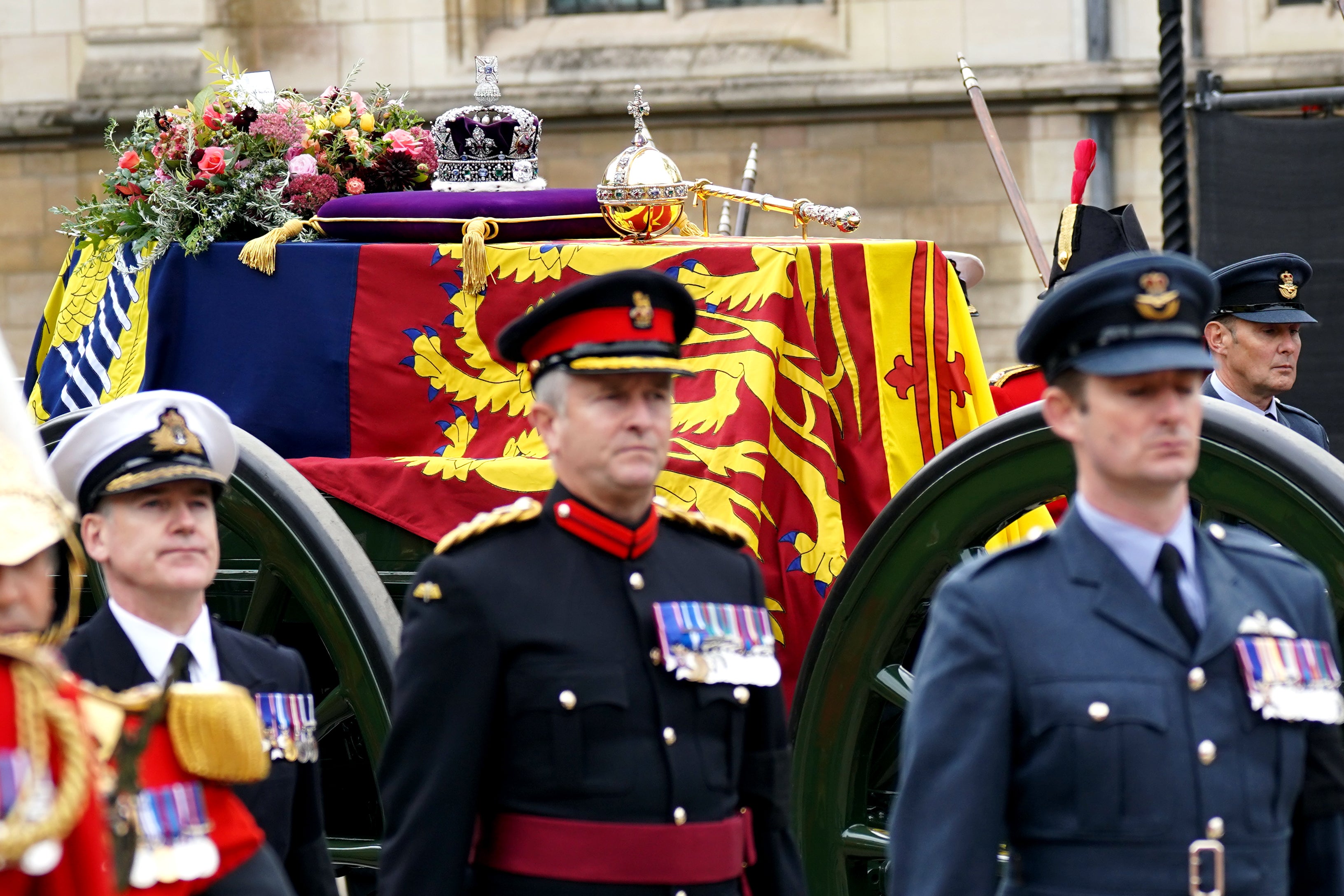 The state gun carriage carries the coffin of Queen Elizabeth II, draped in the royal standard with the imperial state crown and the sovereign’s orb and sceptre, as it leaves Westminster Hall