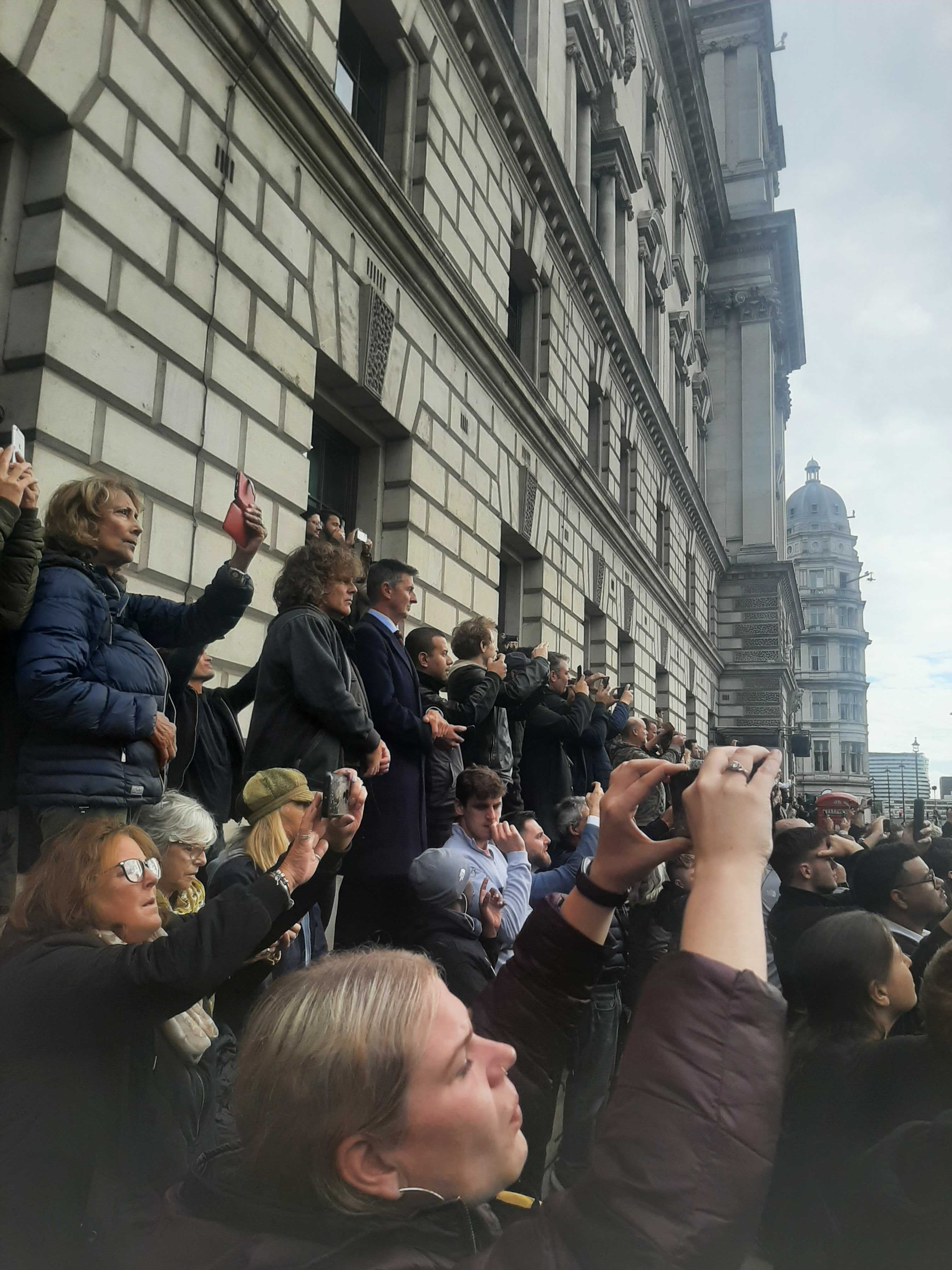 Mourners try to catch a glimpse of the Queen’s coffin on the way to the state funeral