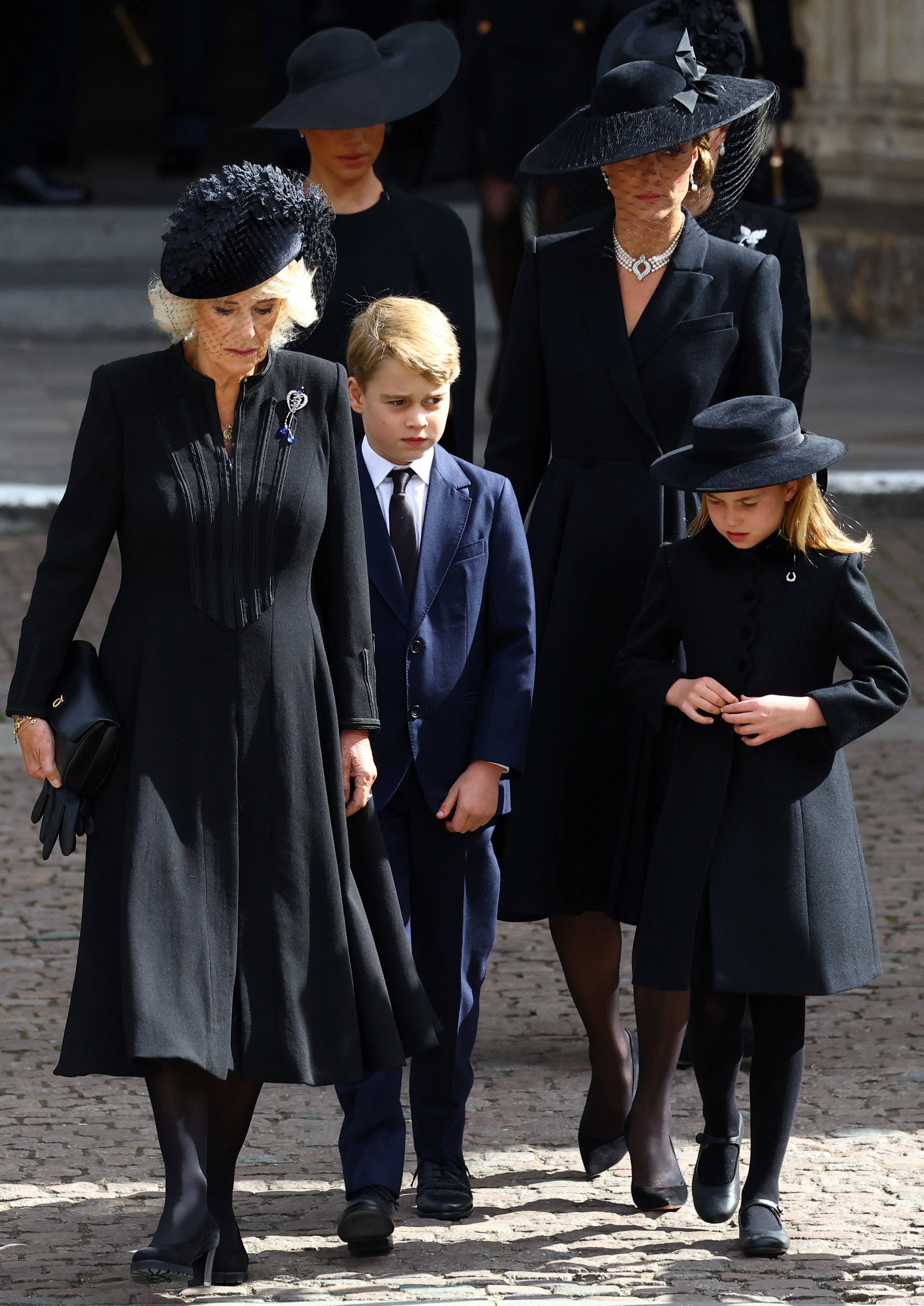 Queen Camilla, Prince George, Princess Charlotte, Catherine, Princess of Wales, and Meghan, Duchess of Sussex, walk after a service at Westminster Abbey on the day of the state funeral and burial of Britain's Queen Elizabeth