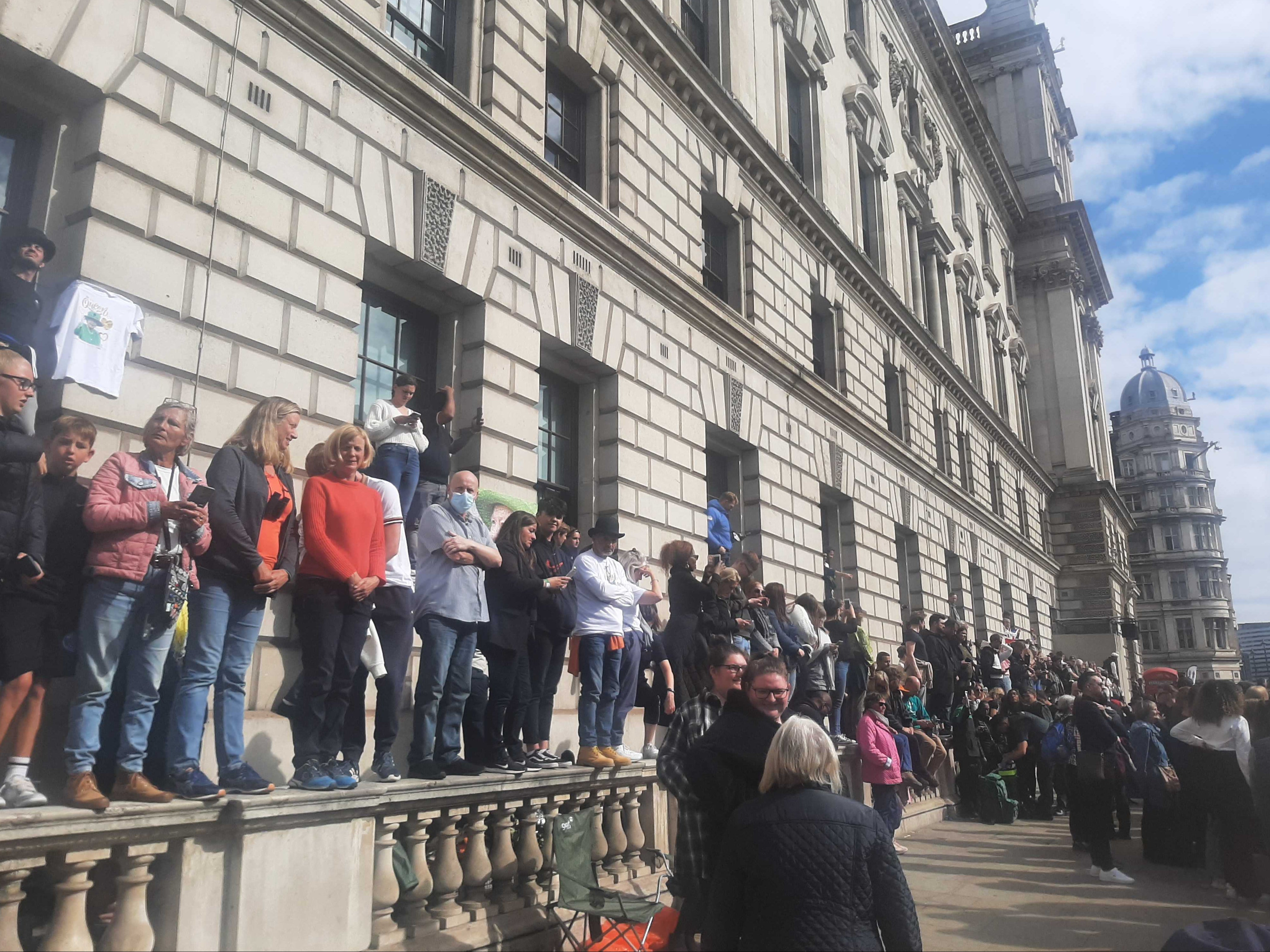 Mourners stood on walls and window sills in hope of getting a good view of the funeral procession