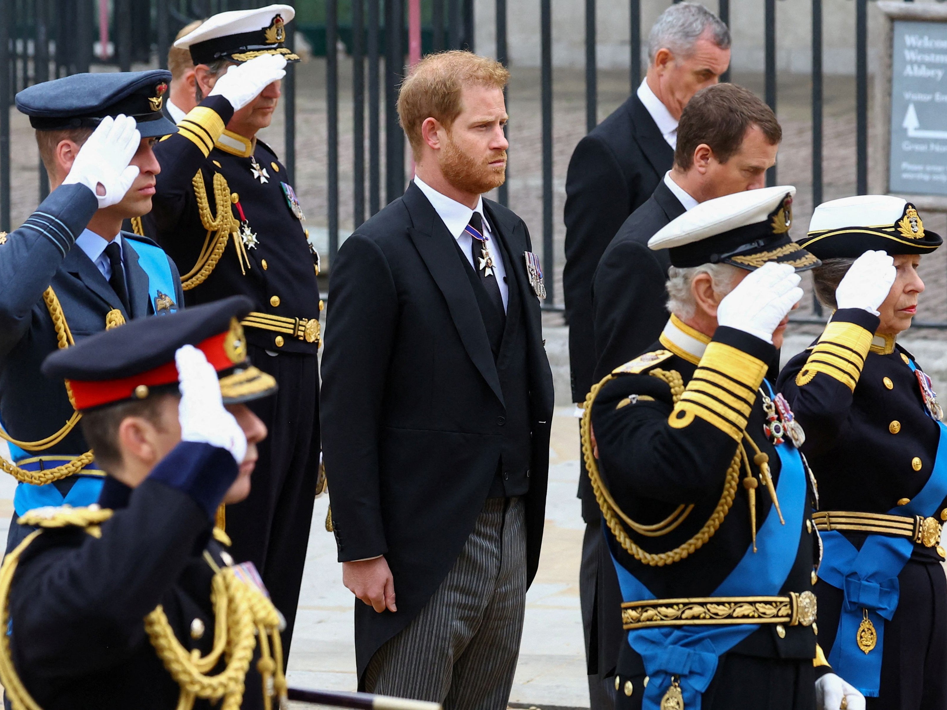 Prince Harry, Duke of Sussex, stands next to King Charles III, Princess Anne, Princess Royal, and Prince William, Prince of Wales, as they salute for the state funeral for Queen Elizabeth II