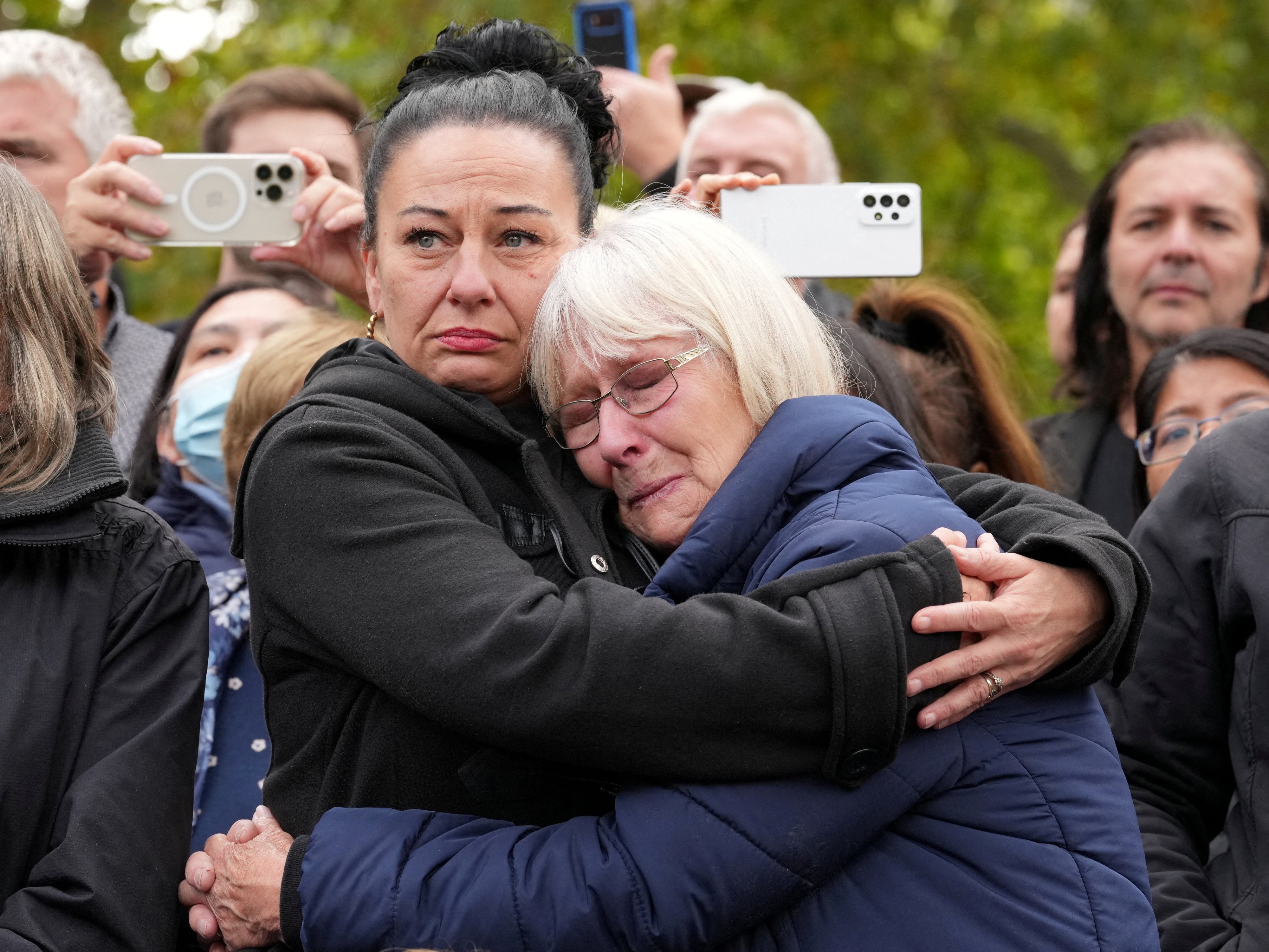 Mourners embrace on The Mall as thousands watched the Queen’s last journey