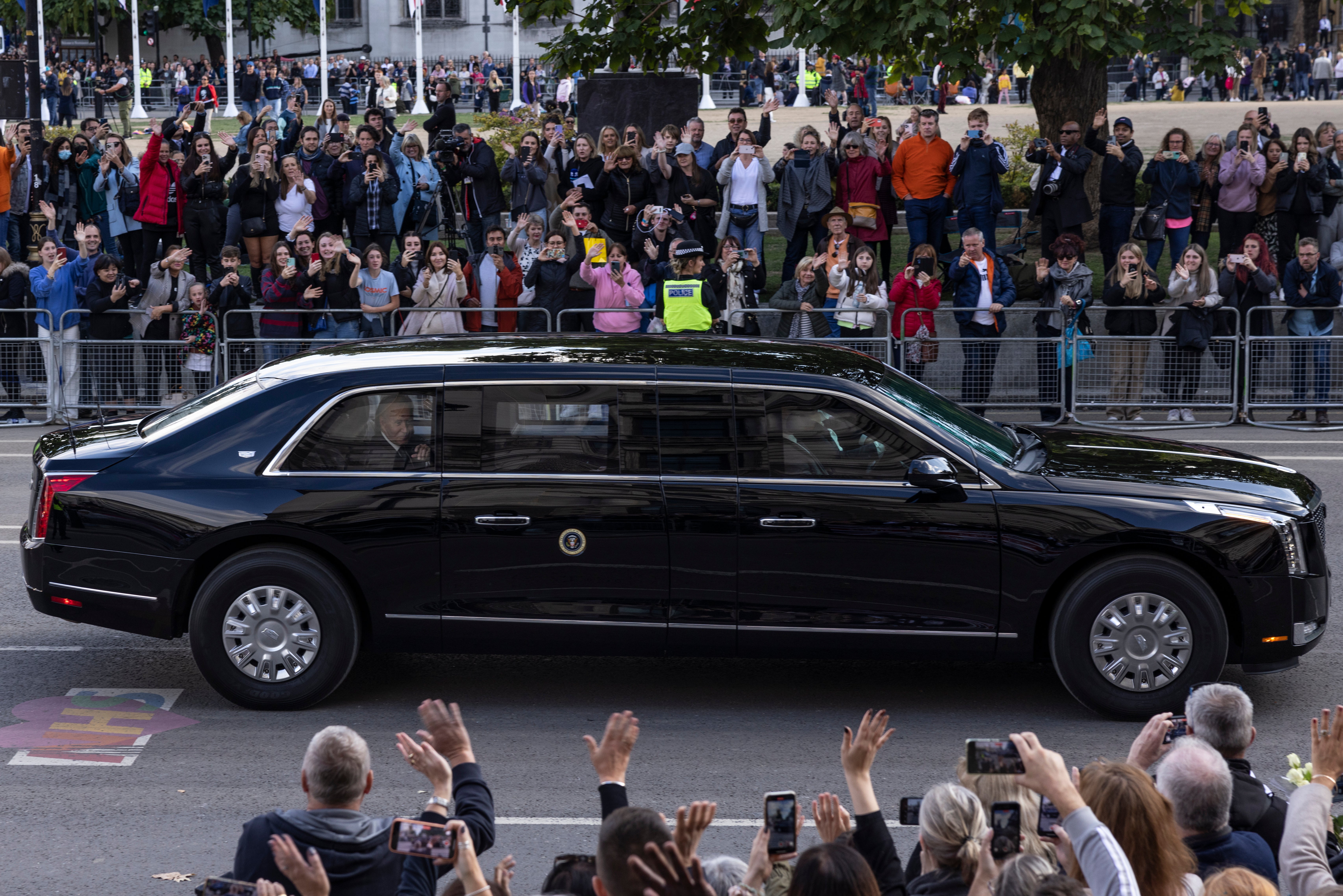 Joe Biden and first lady Jill Biden wave to the crowd from ‘The Beast’ after paying their respects to Queen Elizabeth II at her funeral in London on 18 September 2022