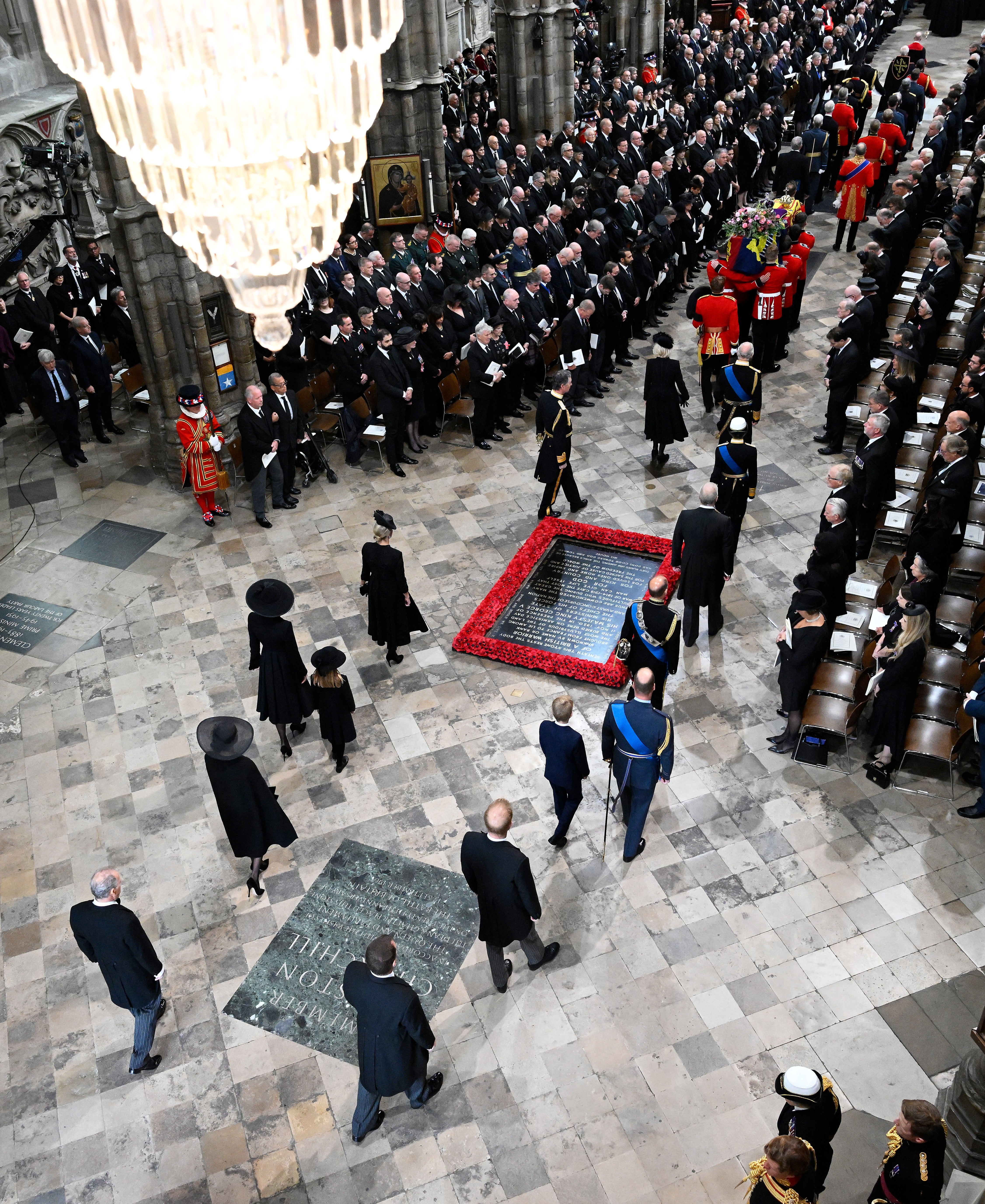 The tomb of the unknown soldier lies surrounded in poppies on the floor of Westminster Abbey.