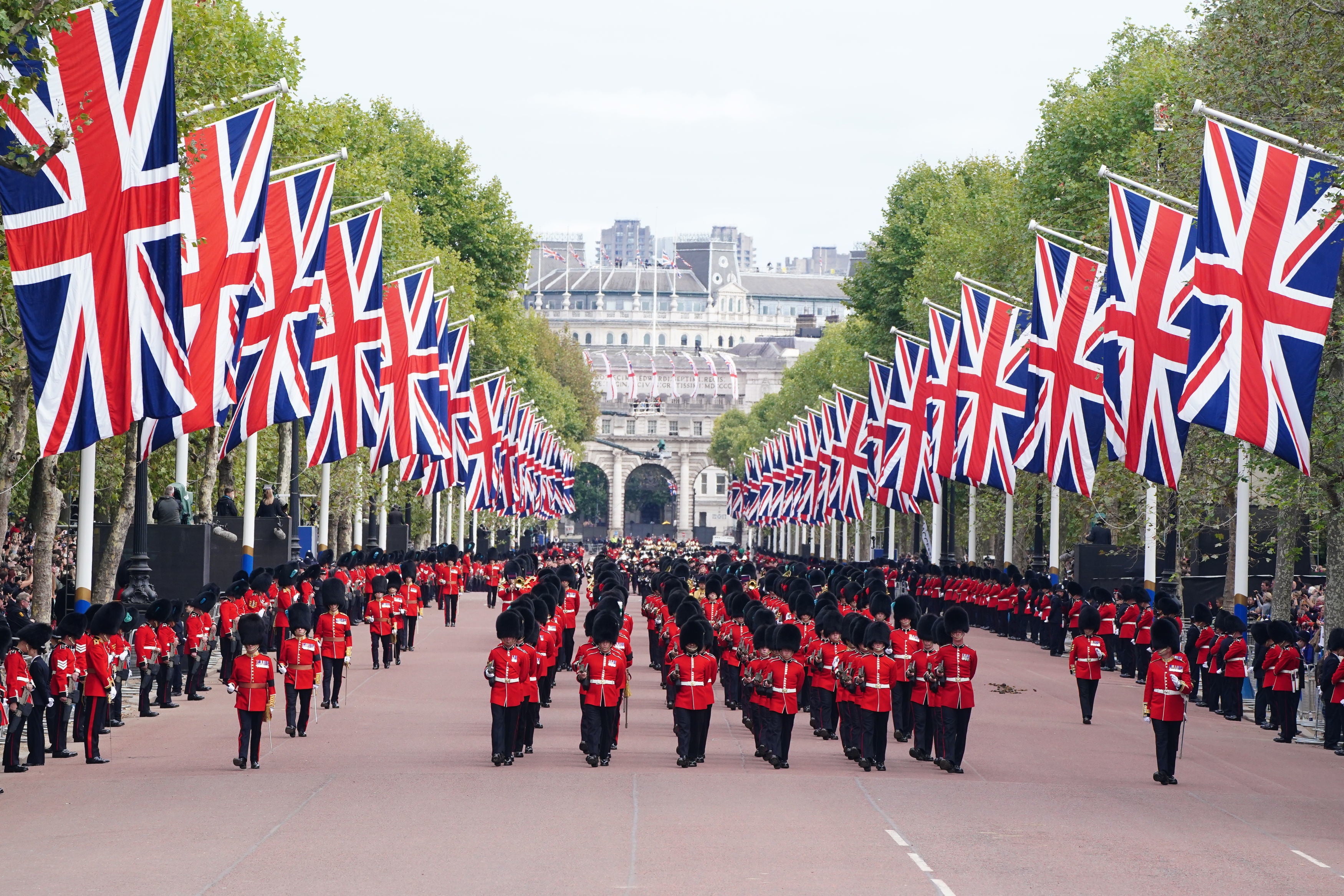 The State Gun Carriage carries the coffin of Queen Elizabeth II, draped in the Royal Standard with the Imperial State Crown and the Sovereign's orb and sceptre, in the Ceremonial Procession following her State Funeral at Westminster Abbey, London.