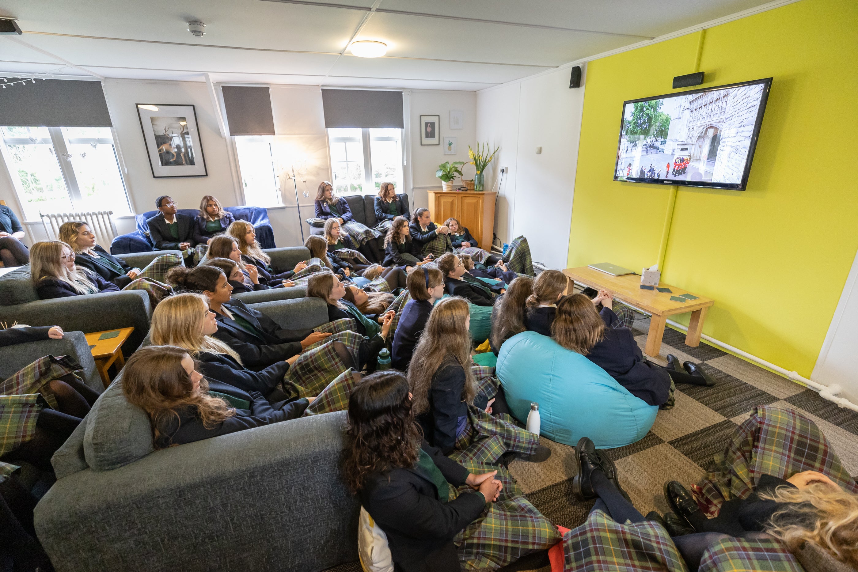 Students watch the state funeral of Queen Elizabeth II in their boarding house, Windmill Lodge, at Gordonstoun School (Paul Campbell/PA)