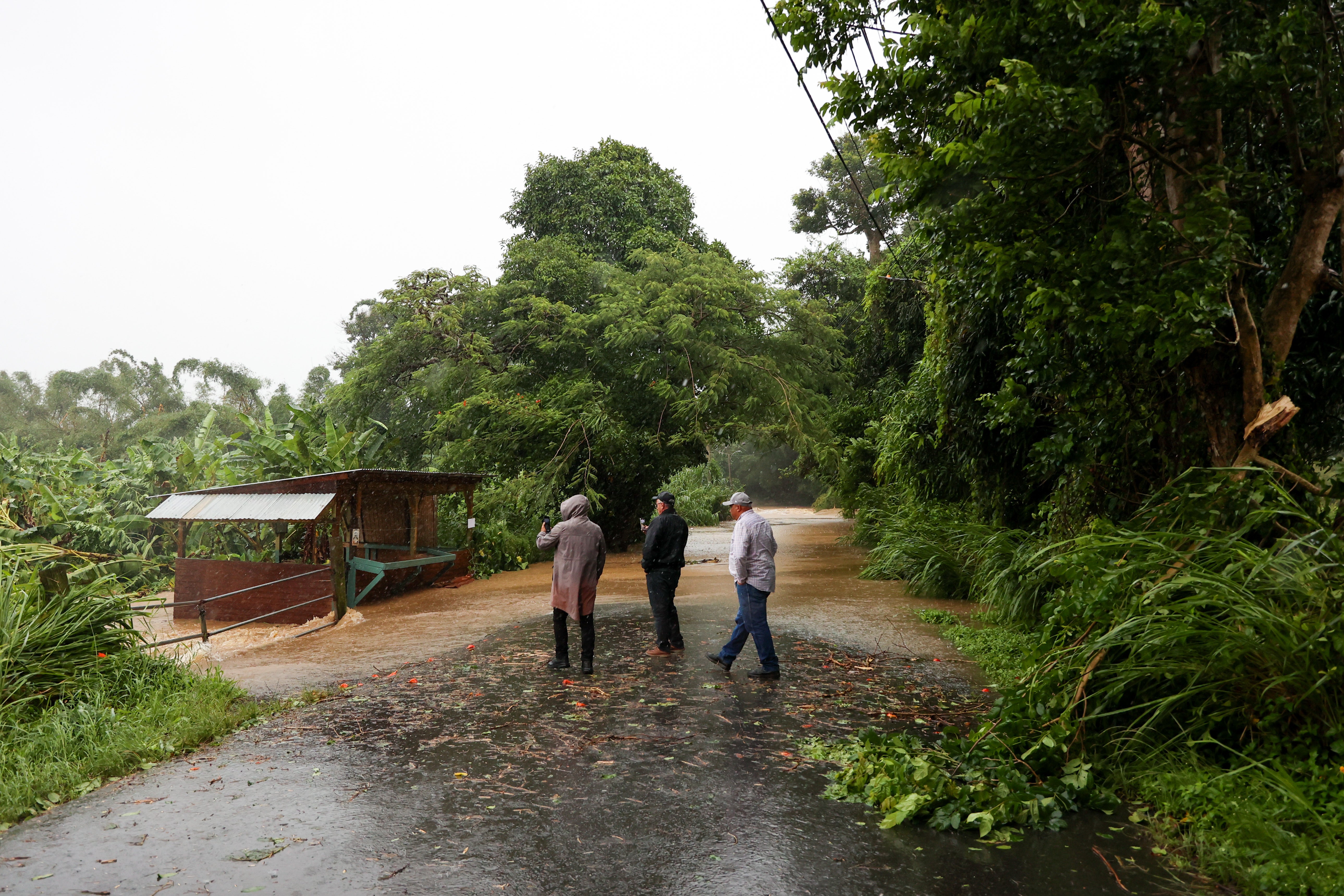 Floods overtake a road in Cayey on Sunday