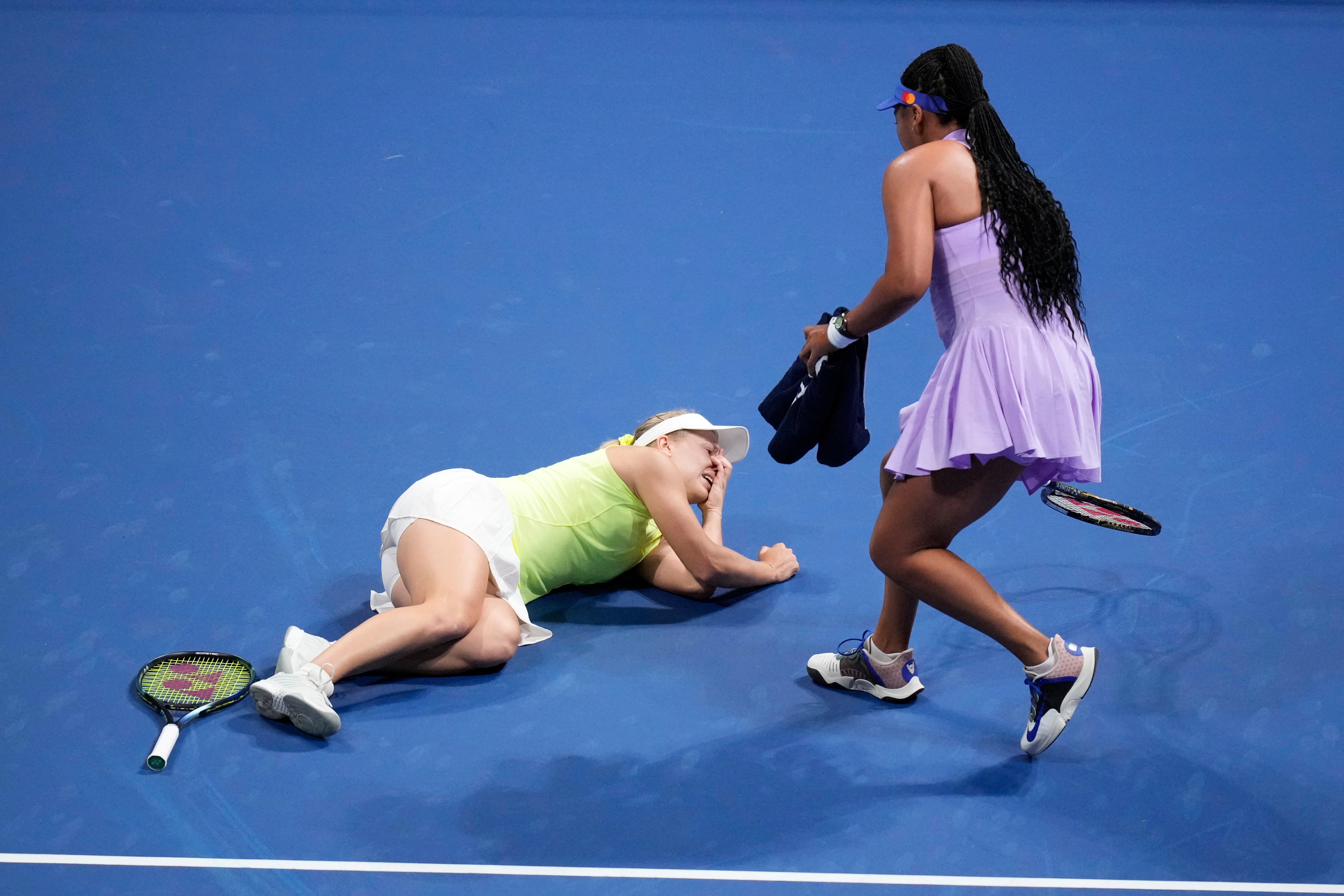 Naomi Osaka rushes to help Daria Saville after she suffered a knee injury (Hiro Komae/AP)