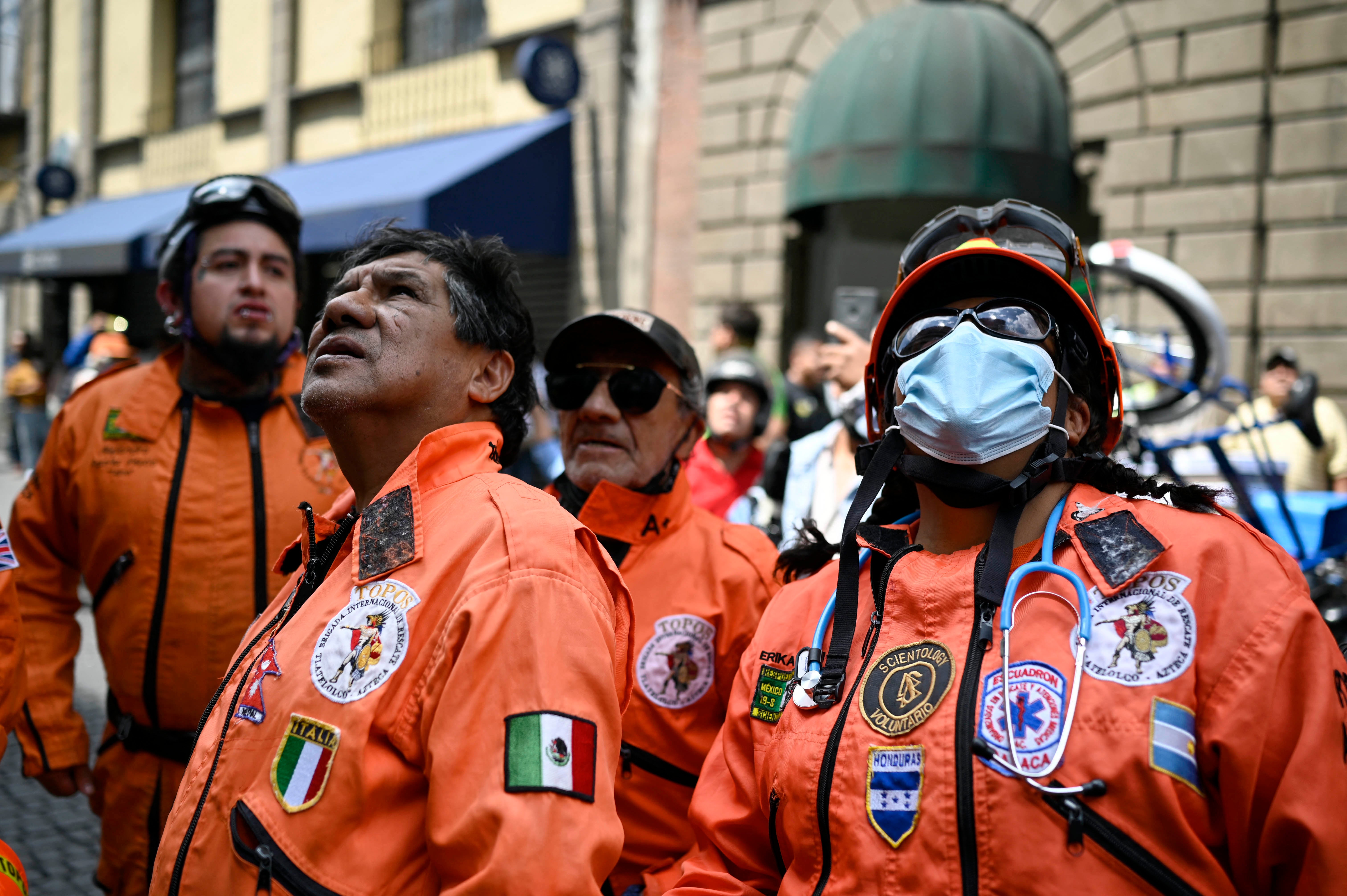 Rescuers look at damages in a building after an eartquake in Mexico City on September 19, 2022