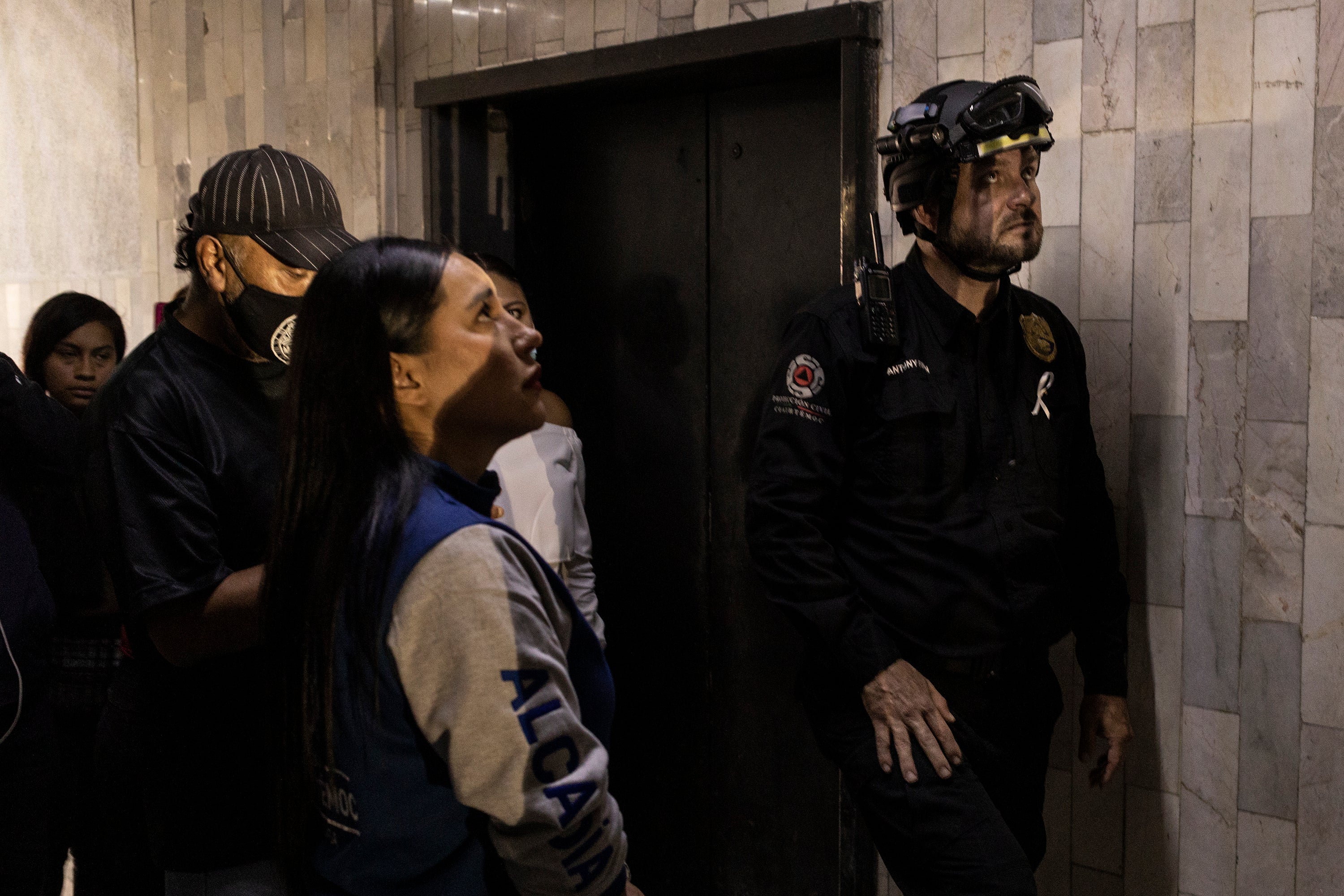 Civil protection members conduct tours on a building after a 7.7 magnitude quake that struck the west coast in Michoacan State, was felt in Mexico City