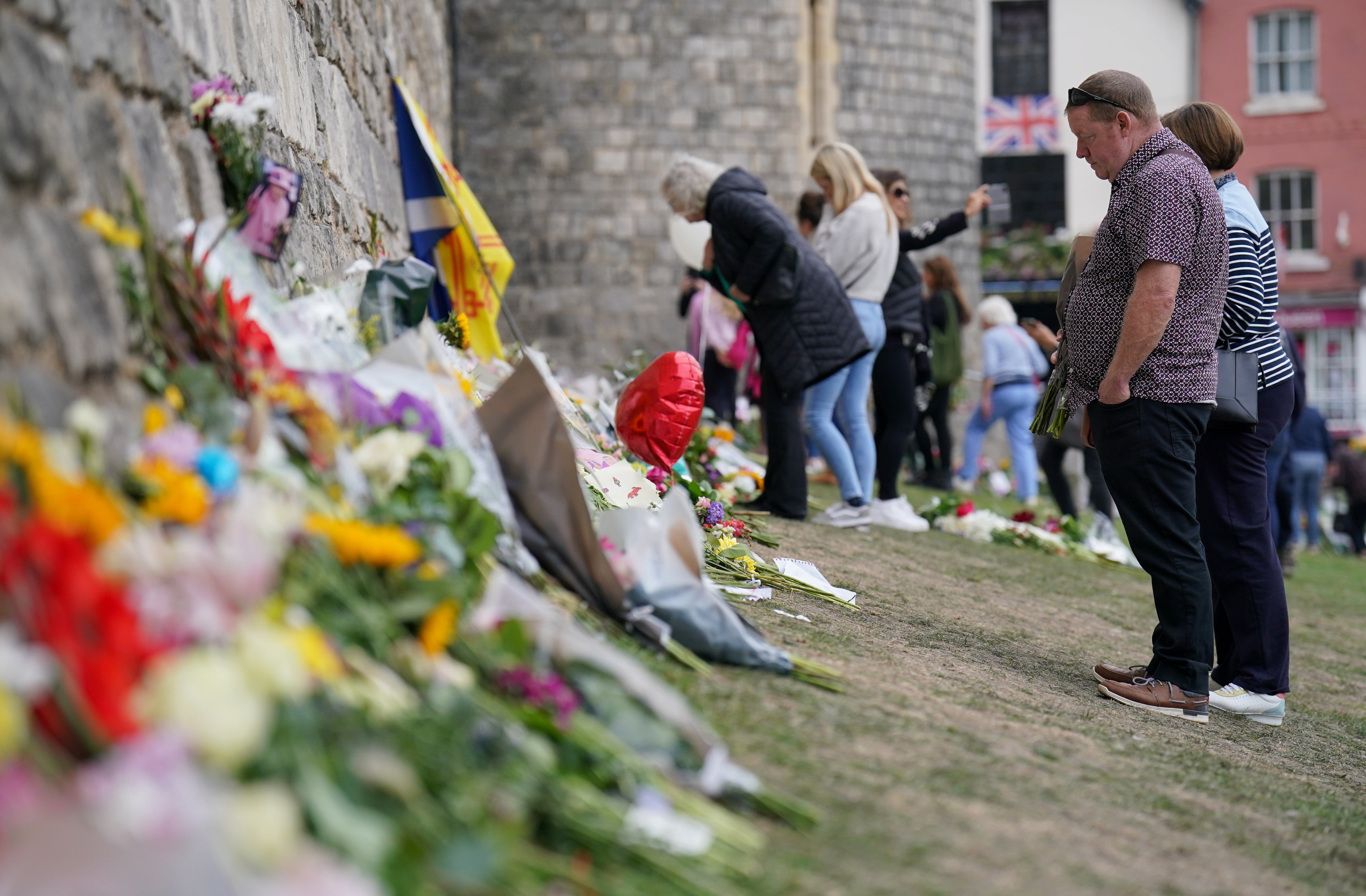 Well-wishers view floral tributes at Windsor Castle in Berkshire (Jonathan Brady/PA)