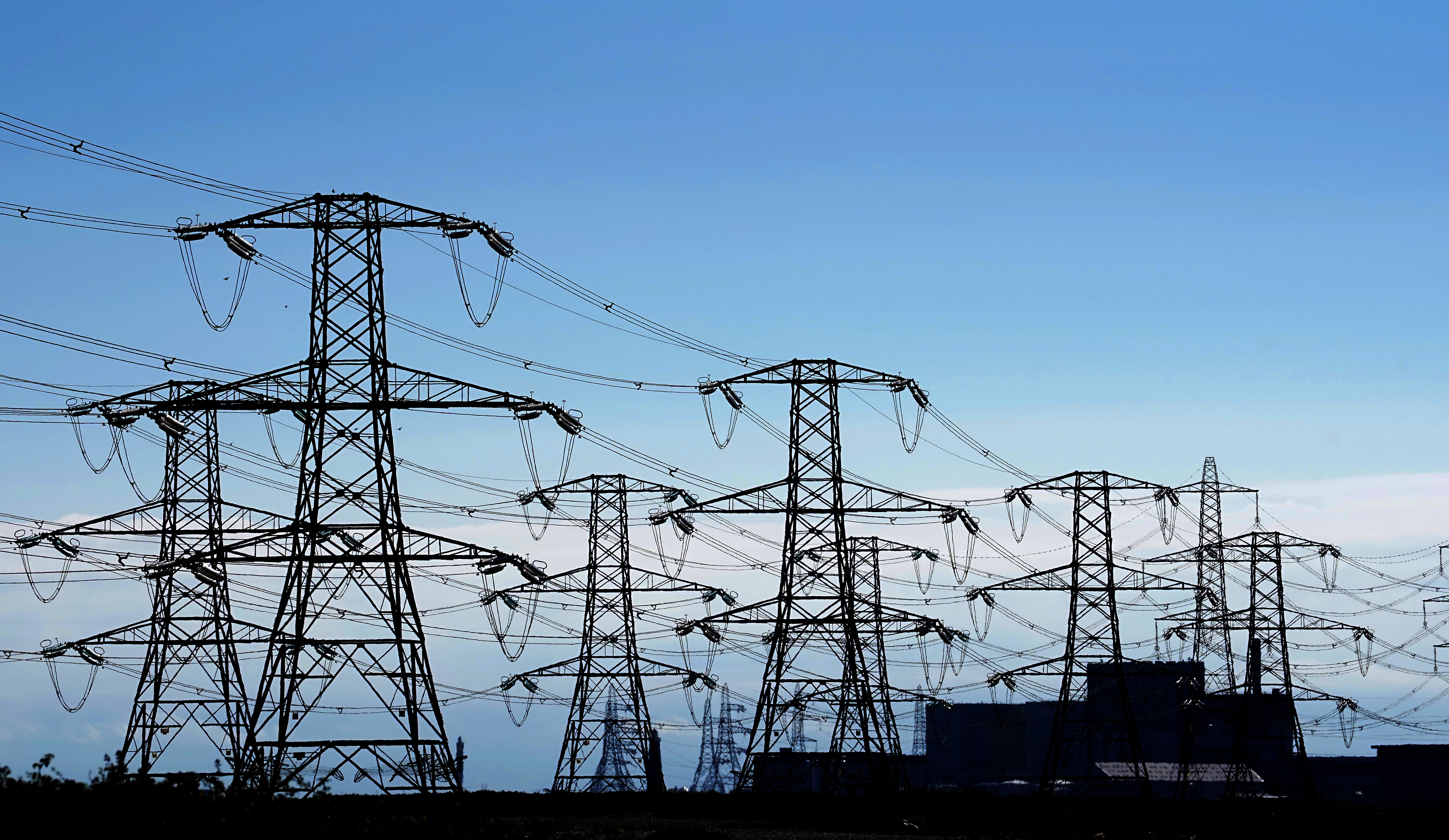 Electricity pylons run across Romney Marsh in Kent from Dungeness nuclear power station