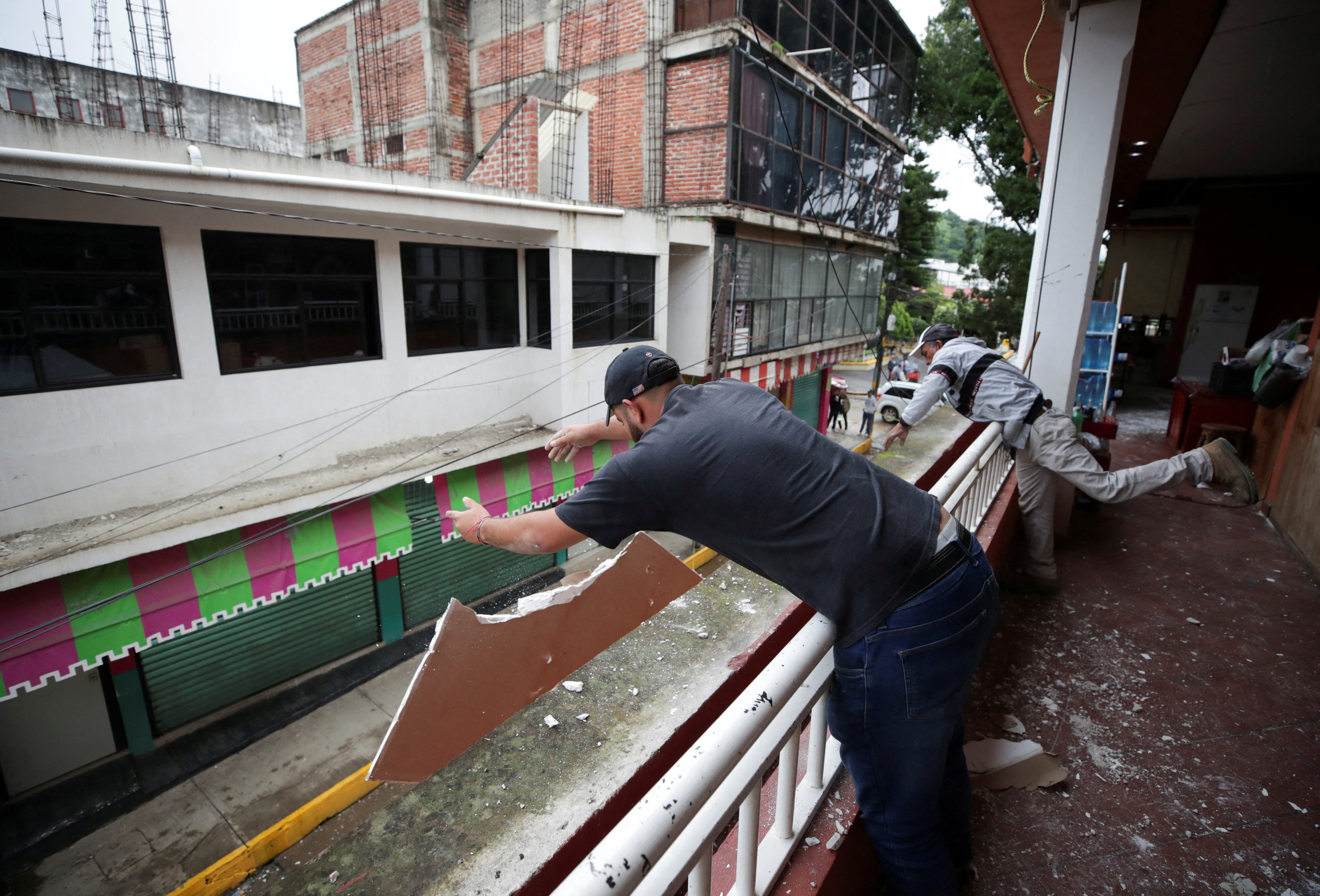 Employees remove debris at a damaged mall after an earthquake on Monday, in Coalcoman, Michoacan, Mexico September 20 2022