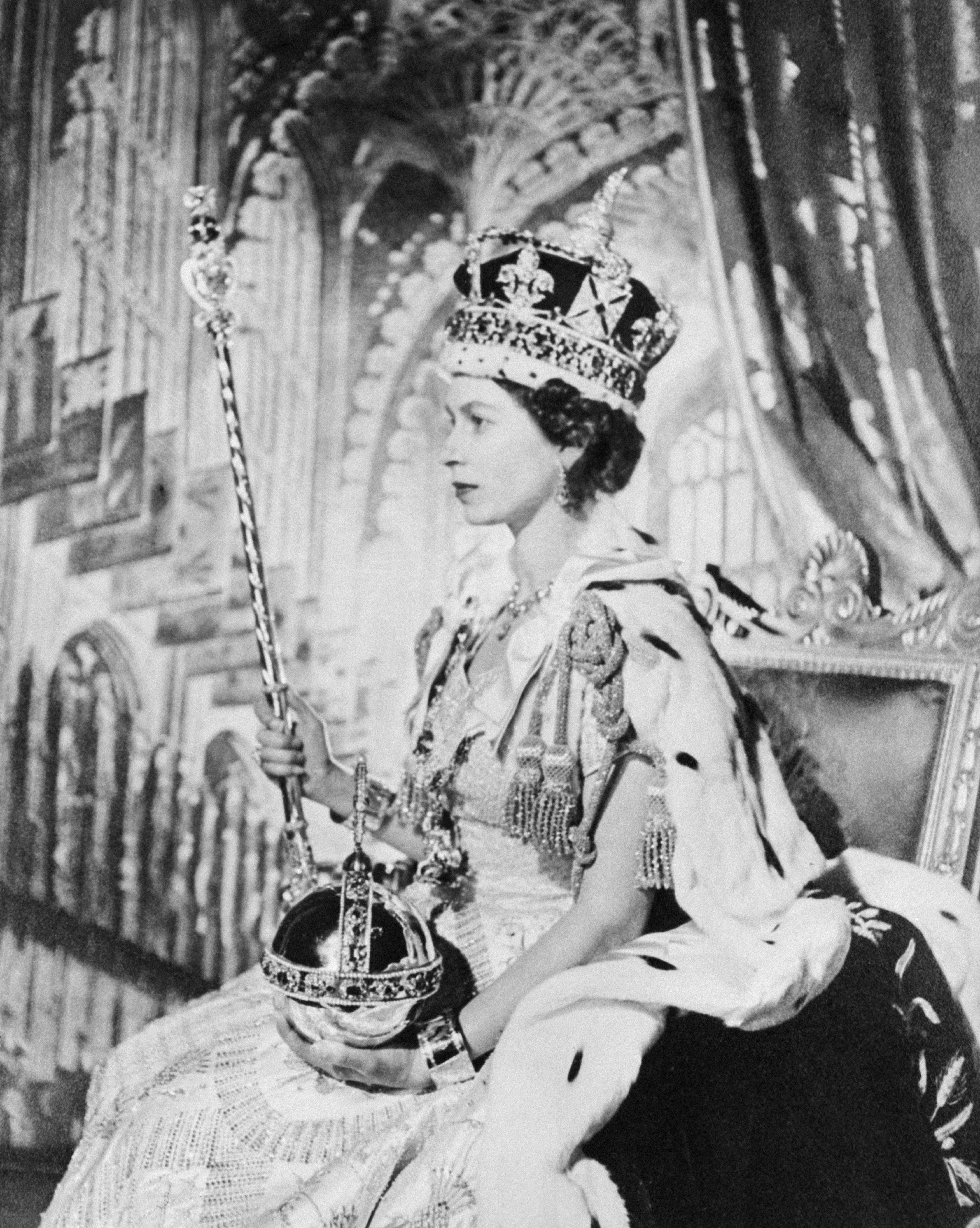 The Queen with the orb, crown and sceptre on her coronation day in 1952