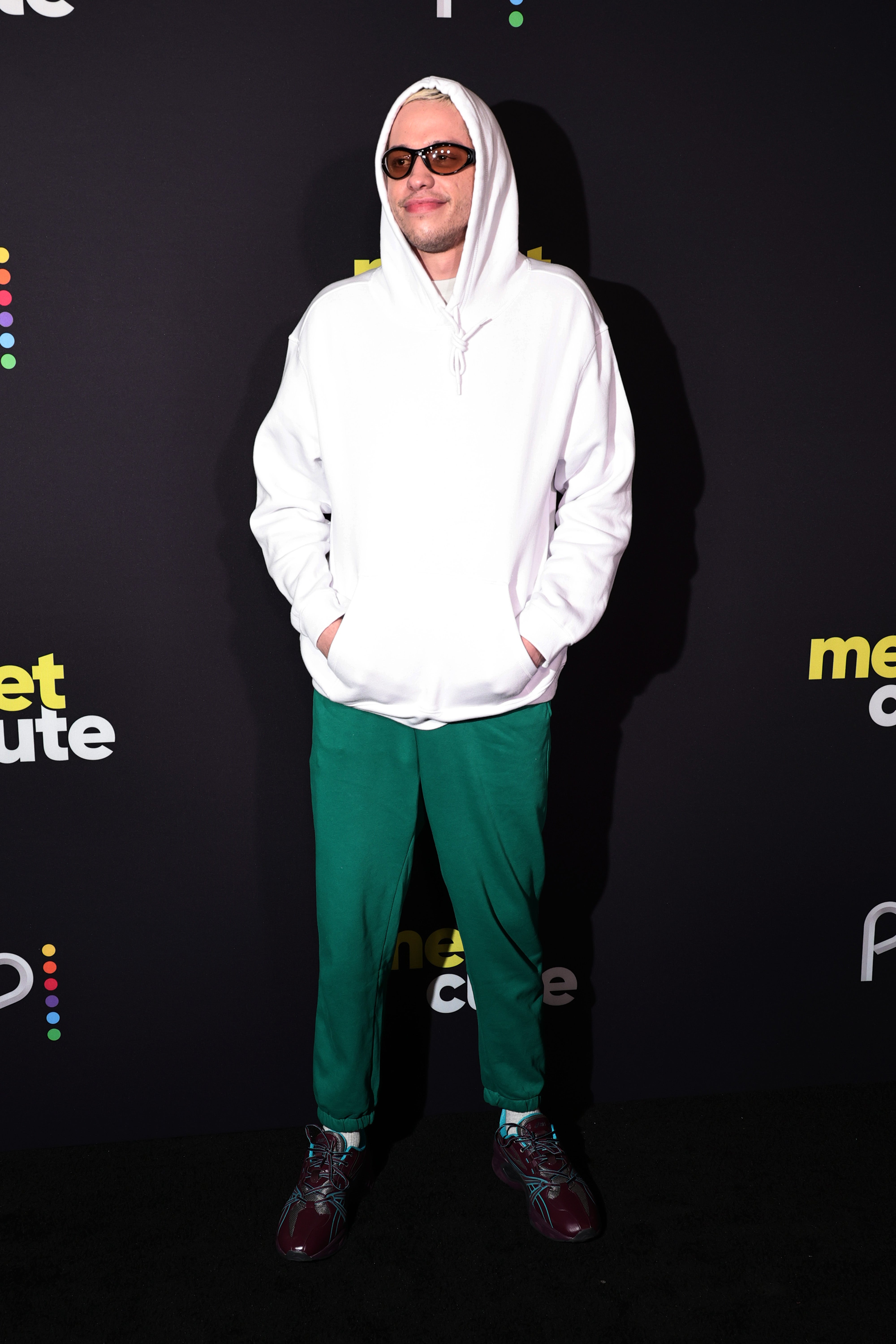 Pete Davidson wears white hoodie and green pants to Meet Cute premiere in New York City