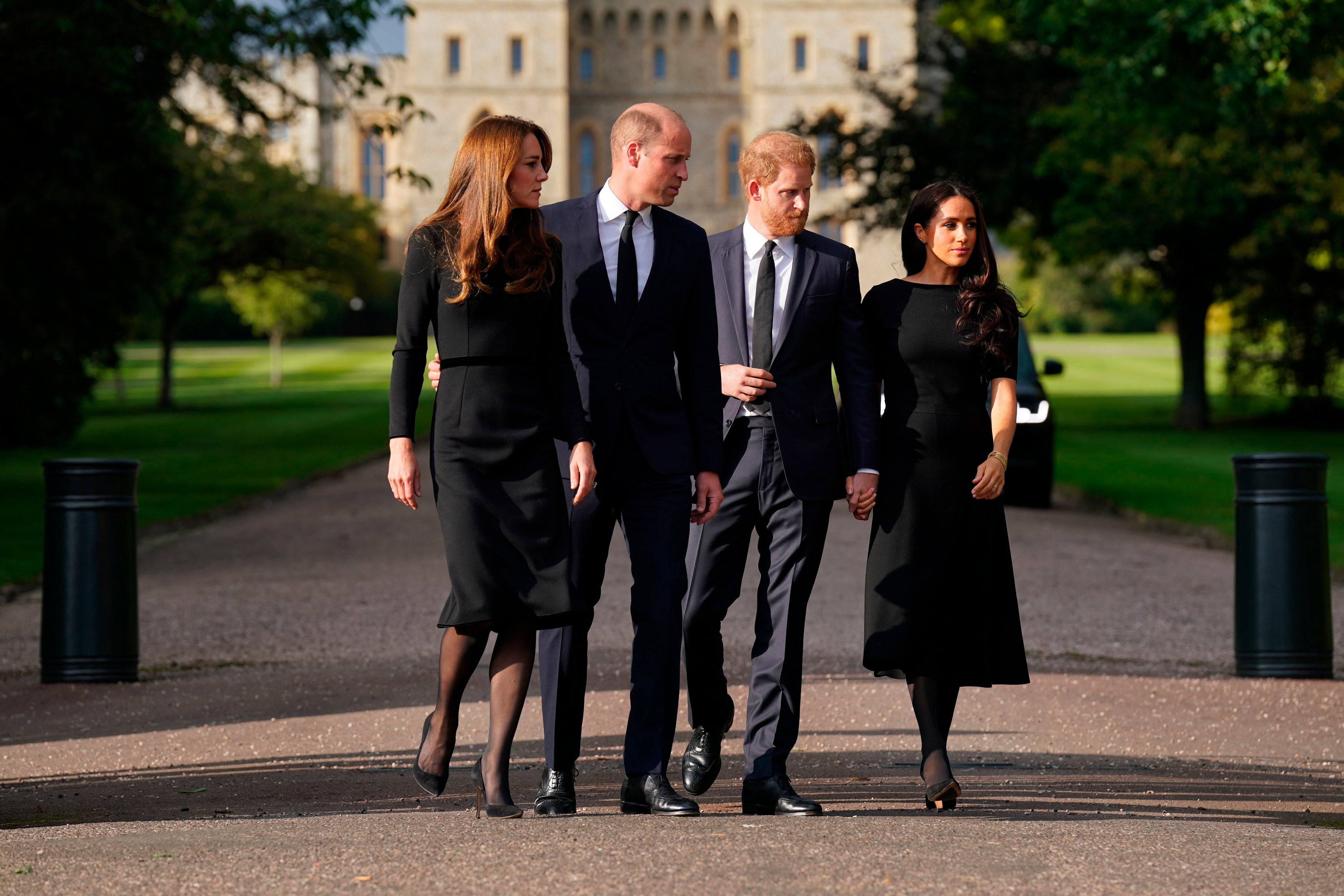 Kate, the Princess of Wales, Prince William, Prince of Wales, Prince Harry and Meghan, Duchess of Sussex walk to meet members of the public at Windsor Castle