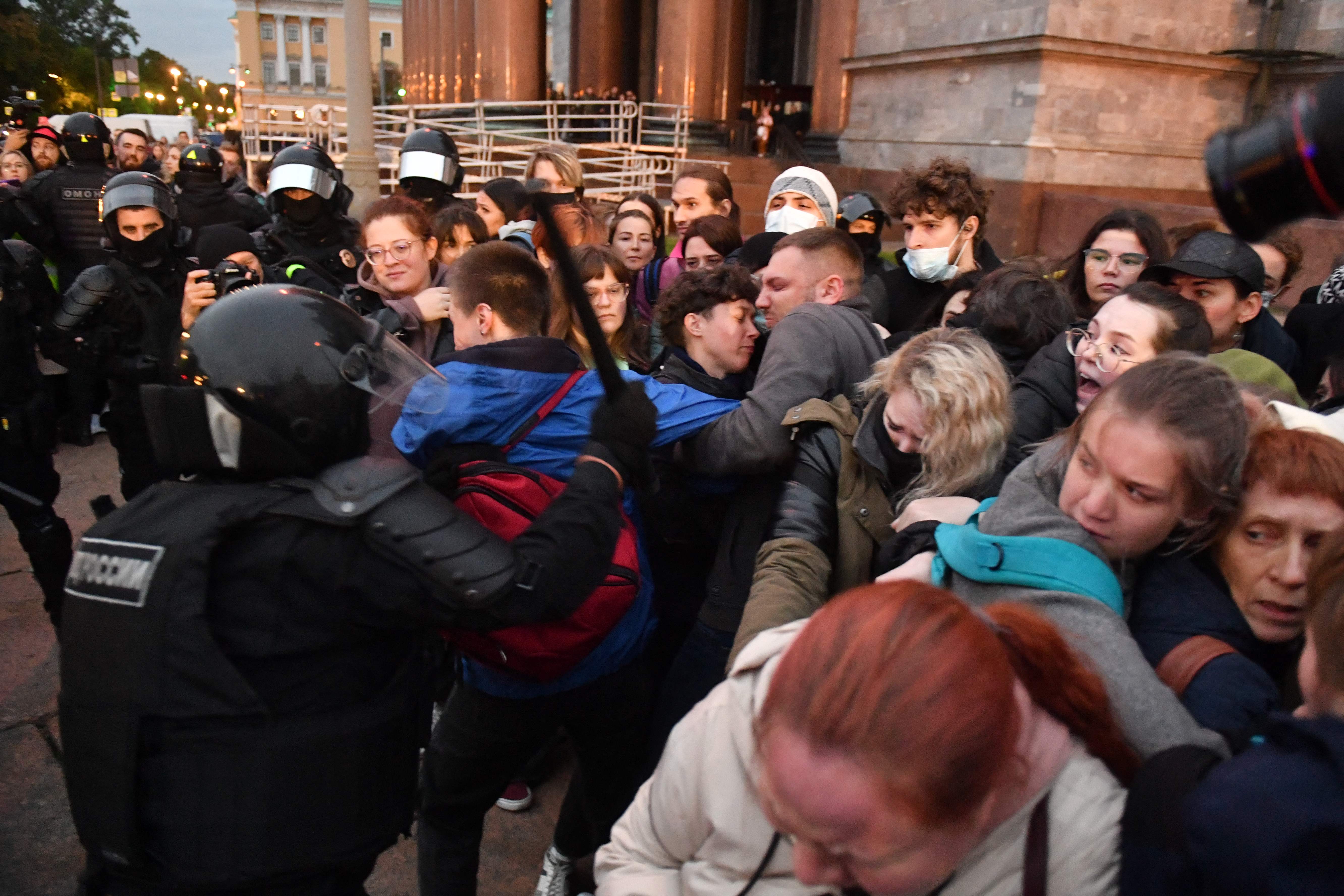 Police officers detain demonstrators in Saint Petersburg