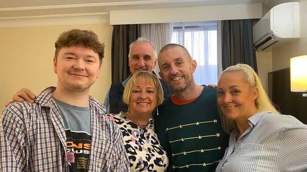 Shaun Pinner (dark top) pictured back in the UK with his family