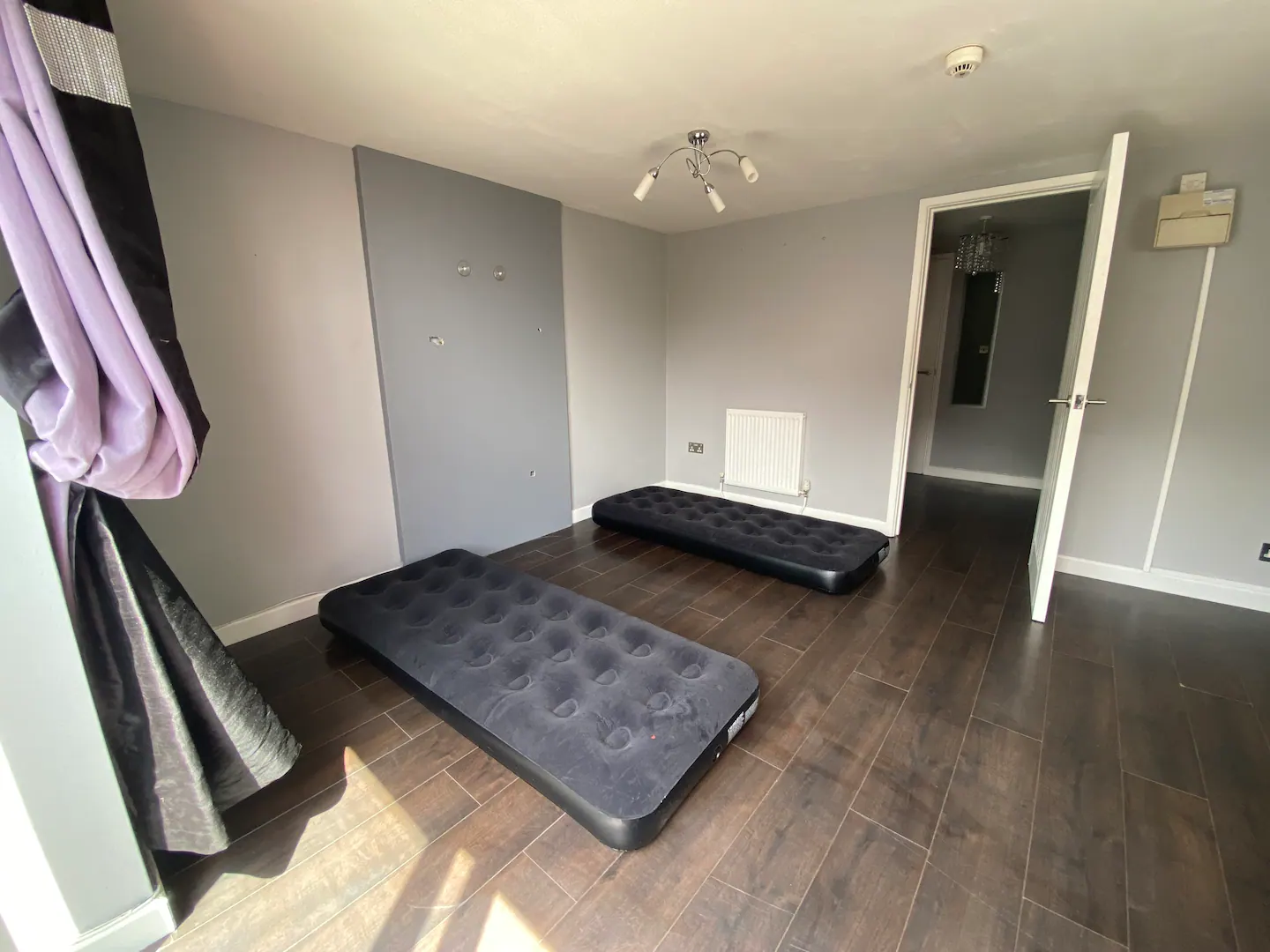 Two single mattresses in the open-plan living room and kitchen serve as some of the beds and seating