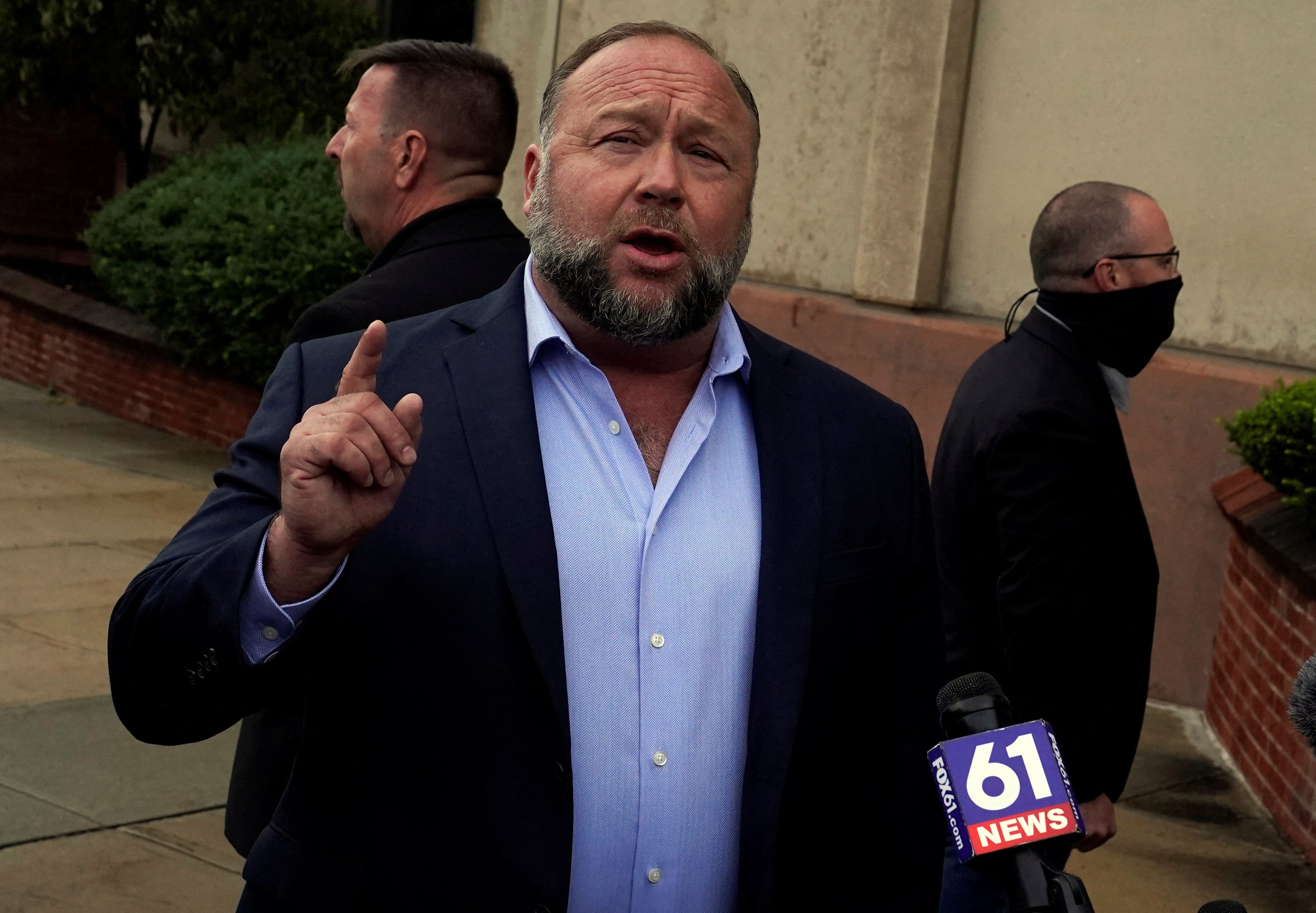 Alex Jones arrives in court to tetsify at his defamation trial on Thursday