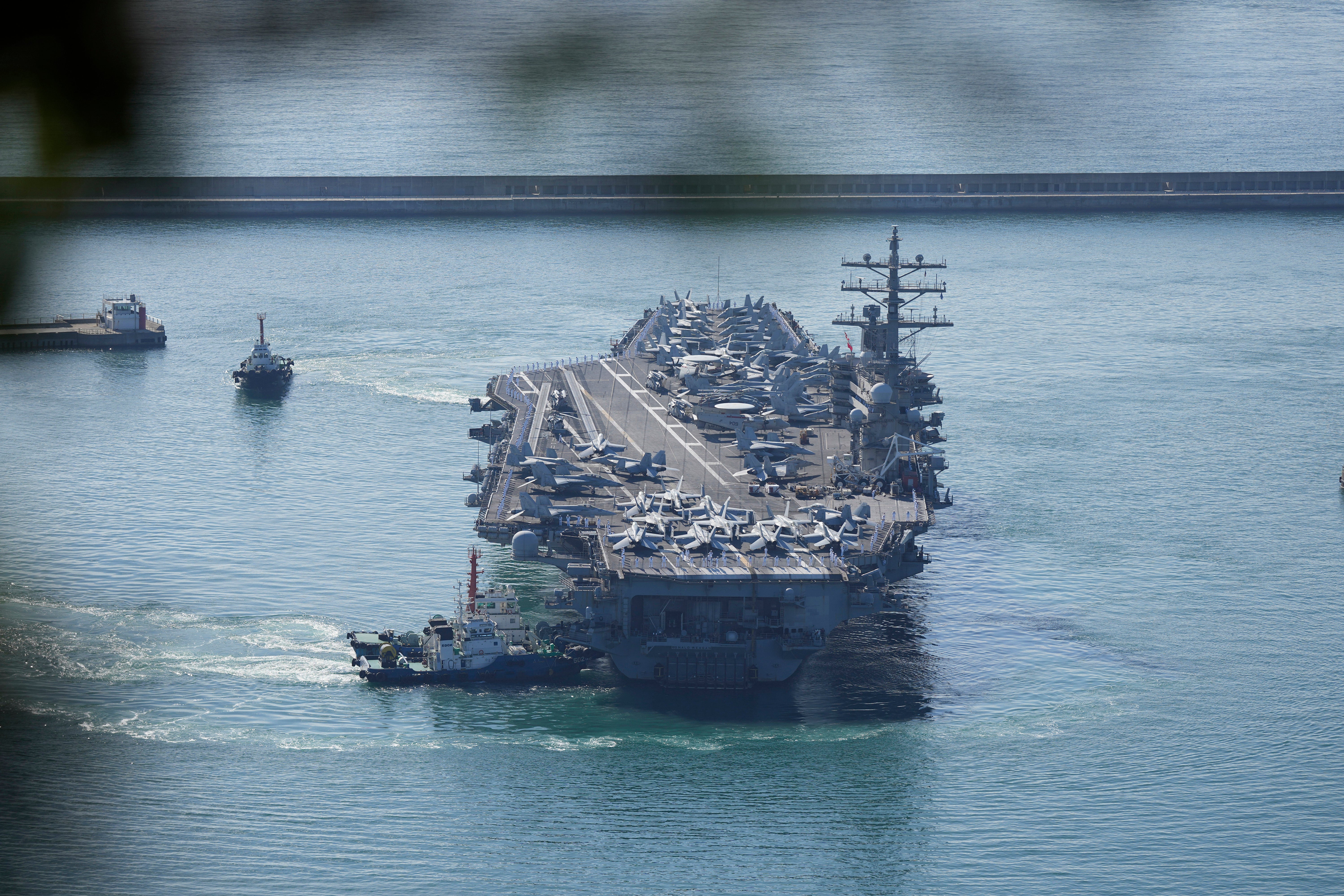 US aircraft carrier USS Ronald Reagan is escorted into Busan Naval Base in Busan, South Korea