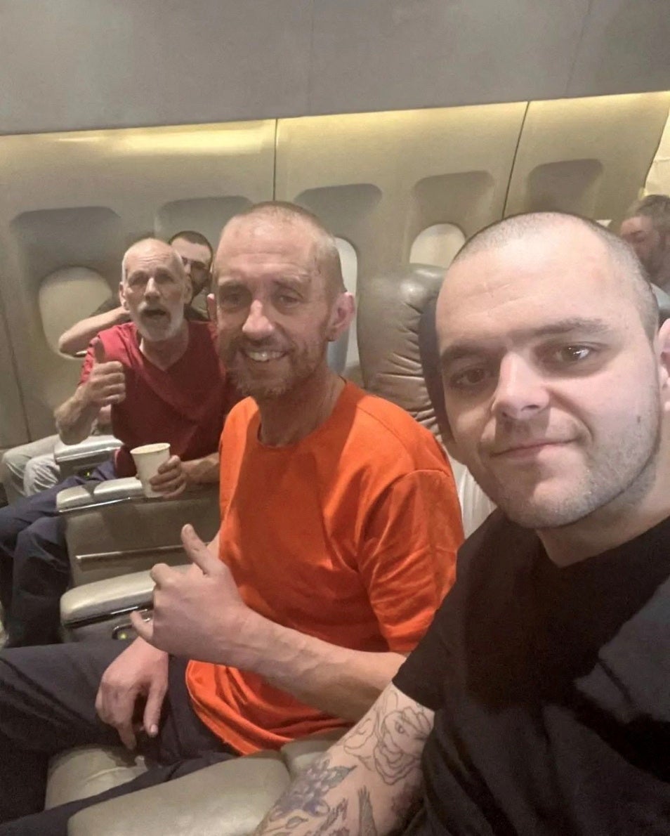 John Harding, Shaun Pinner and Aiden Aslin pictured in plane after their release